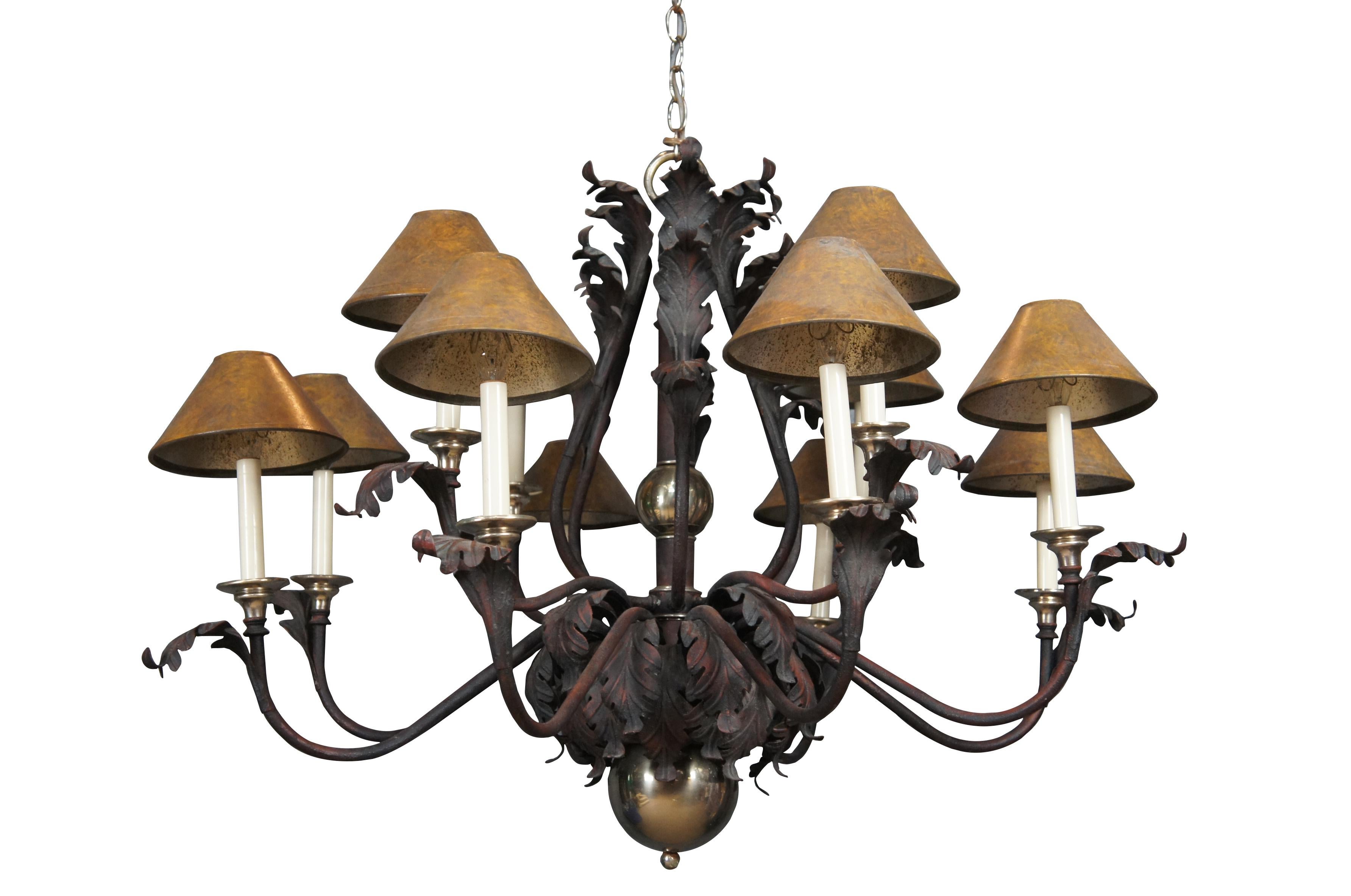 Hart Associates scrolled iron chandelier featuring French acanthus leaf design with twelve candlestick lights and shades, and brass accents..

Dimensions:
44
