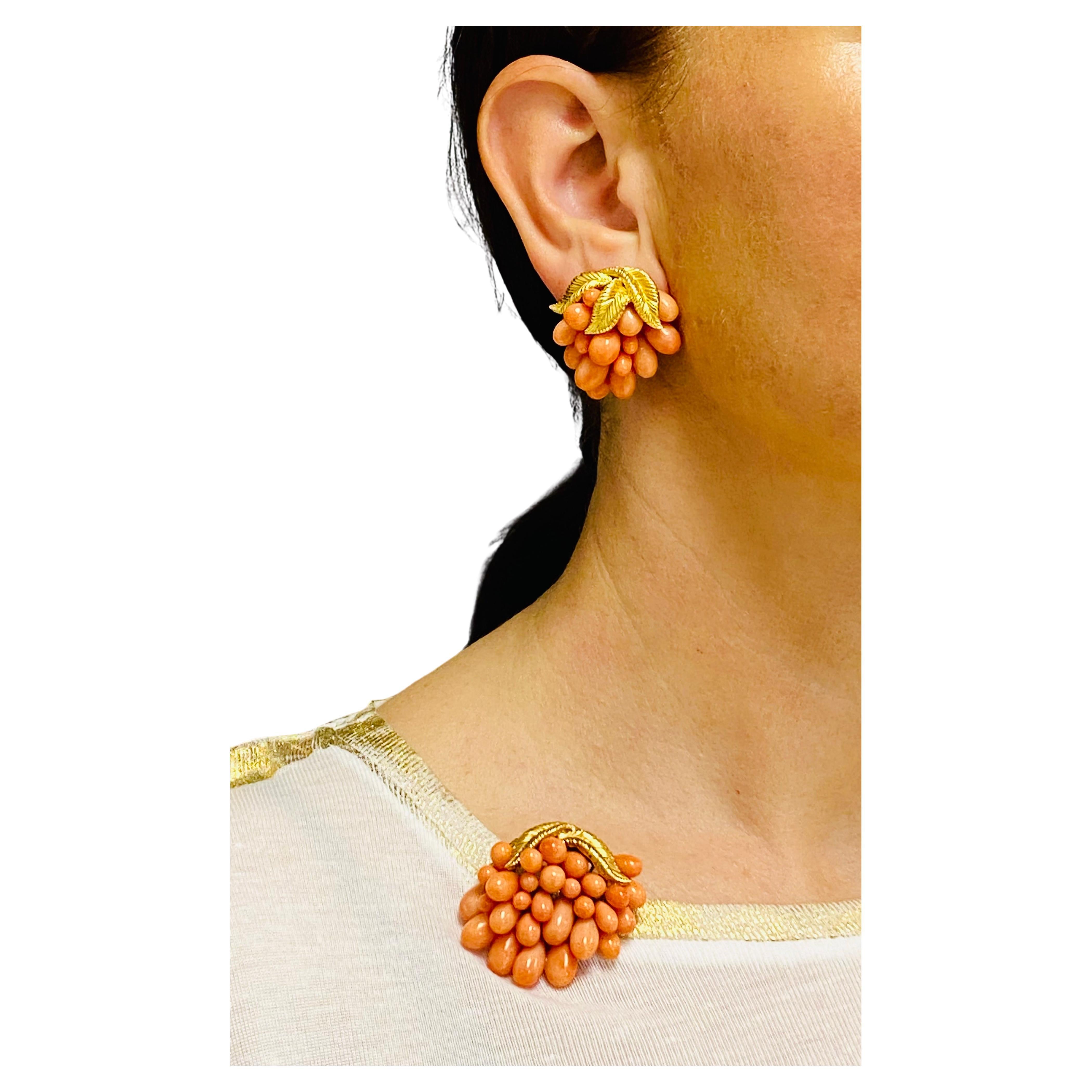 A beautiful vintage French set consisting of the brooch and earrings, made of coral and 18k gold.  The set of botanical design includes the grape cluster earrings and the brooch. The coral has a beautiful salmon to the light orange hue. Glossy coral