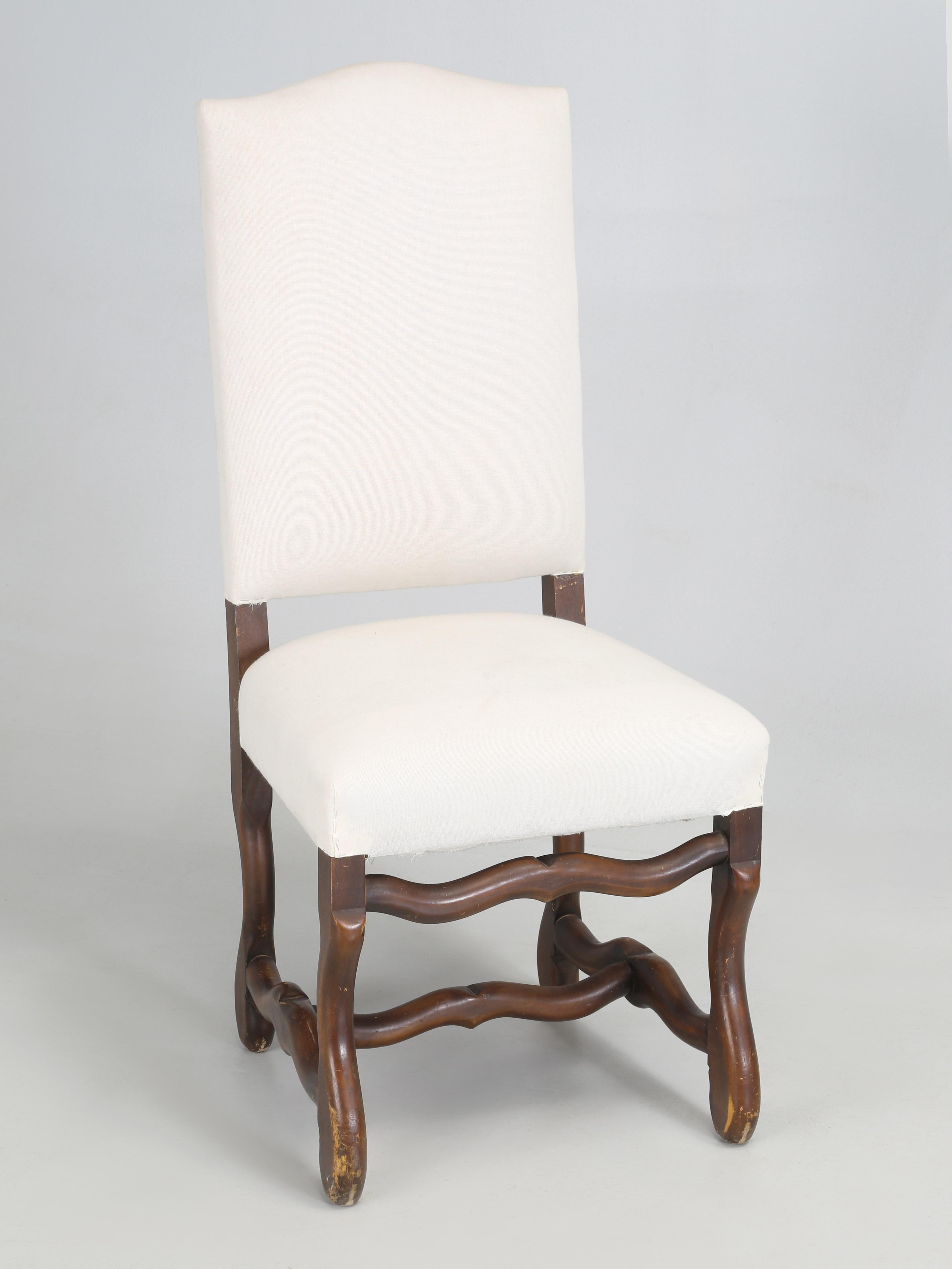 Vintage French Dining Chairs in the style of Os De Mouton, which translate to sheeps horn. Our Old Plank upholstery department disassembled the chairs and re-tied the coil springs 8-ways by hand and used horsehair for padding. What we did not do, is