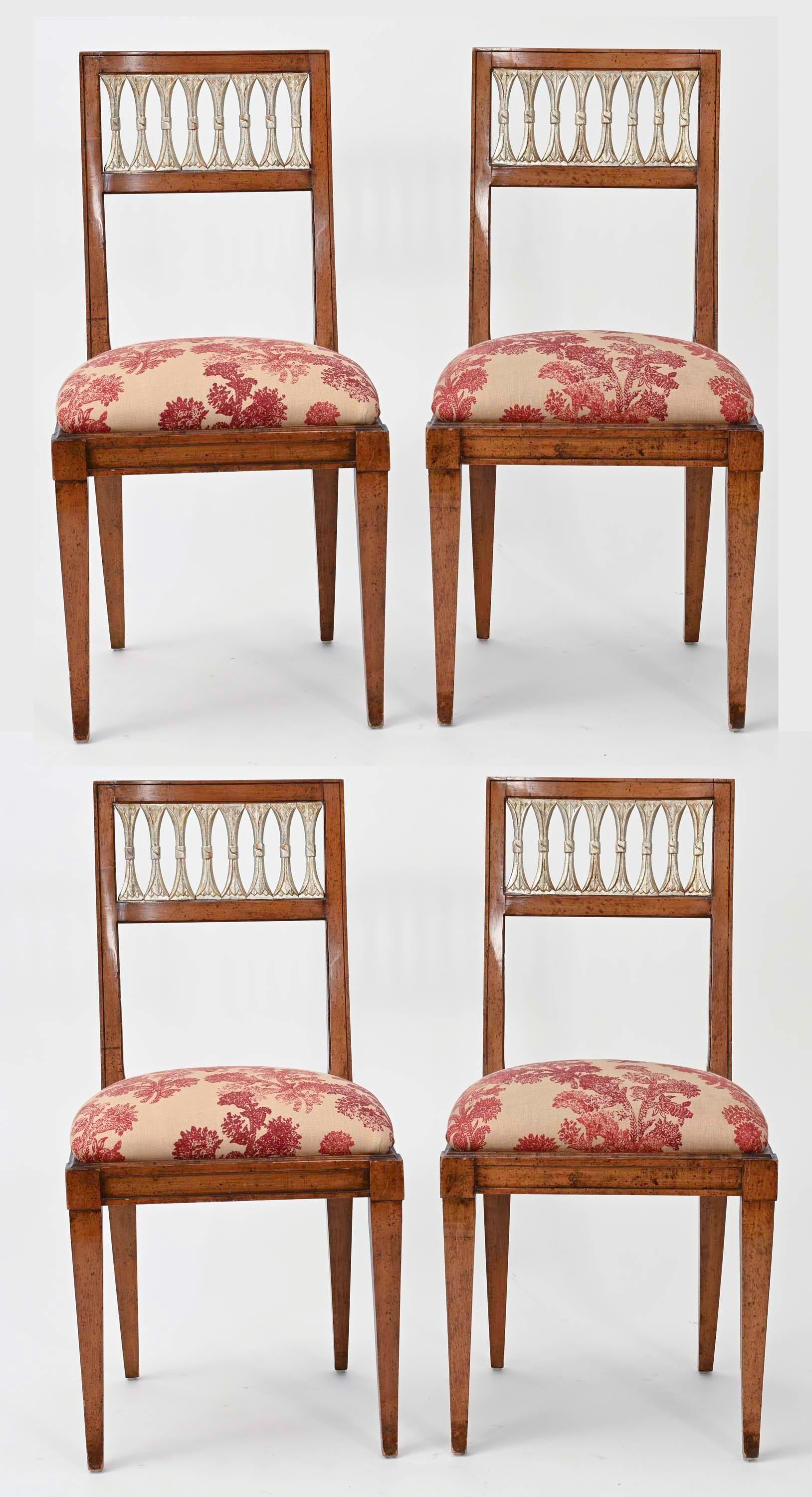 Wonderfully charming set of French side chairs. Solid walnut wood with wonderful patina. Back panels are carved cut ovals finished in accent silver leafing. Newly upholstered in red toil fabric. Very comfortable for breakfast table or game table.