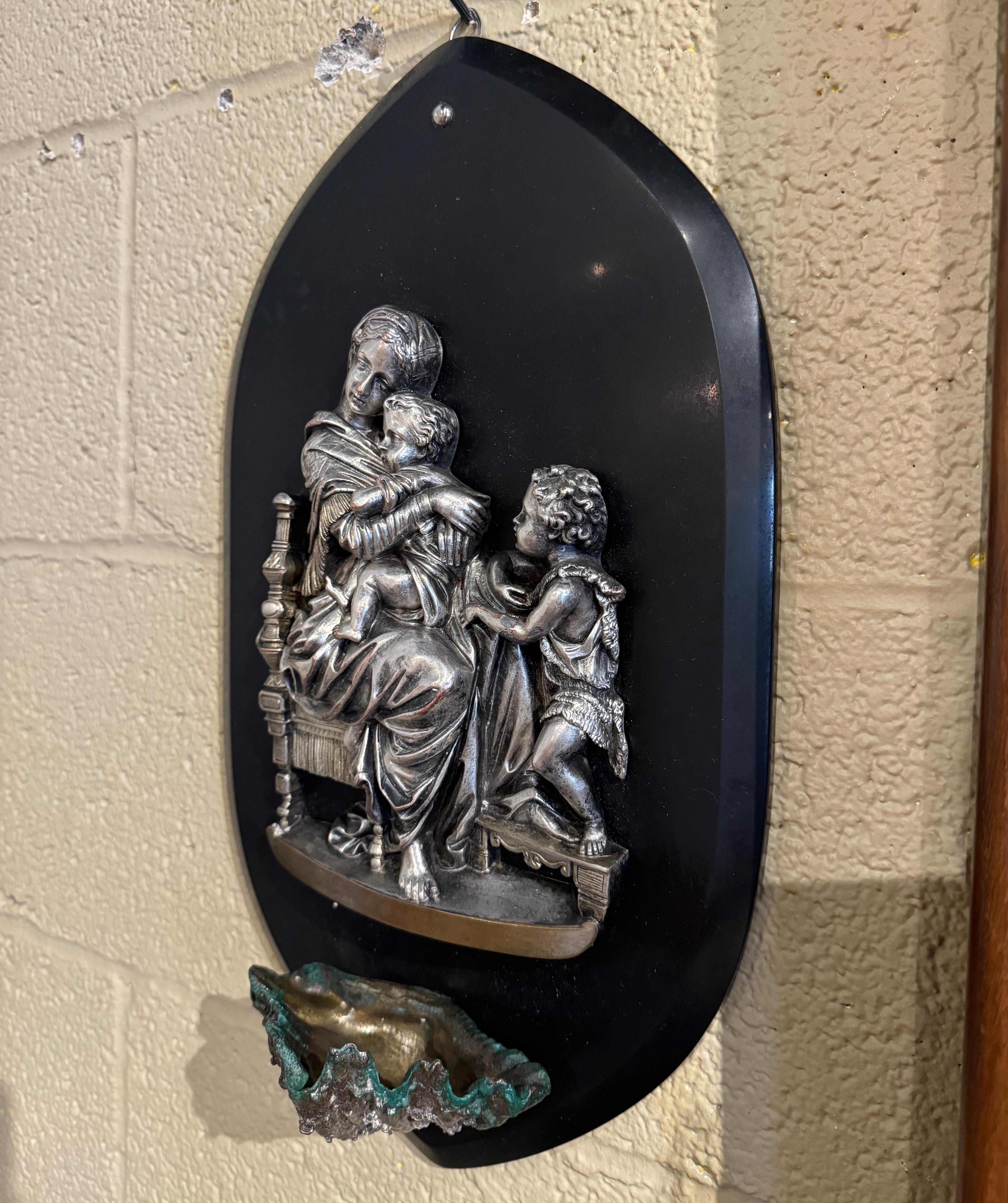 Decorate a chapel or entry with this early 20th-century French holy water stoup. Resting on a black marble plaque, the religious stoup features a finely detailed pewter relief  portraying the Virgin Mary tenderly holding Baby Jesus, with John the
