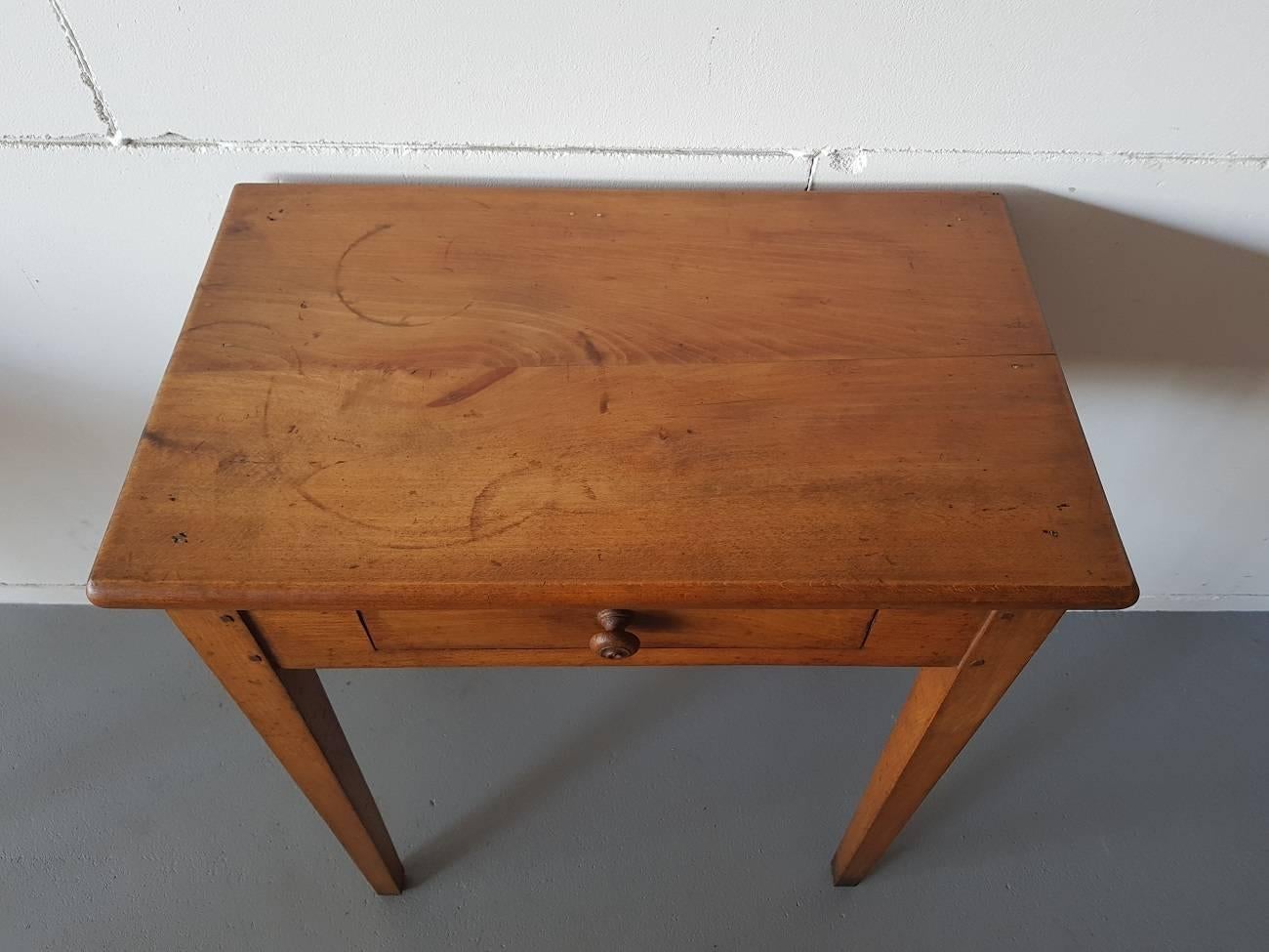 Nice and adorable French vintage wooden table from the first half of the 20th century with a drawer and pinned connections all around.

The measurements are,
Depth 34 cm/ 13.3 inch.
Width 56.5 cm/ 22.2 inch.
Height 68 cm/ 26.7 inch.
 