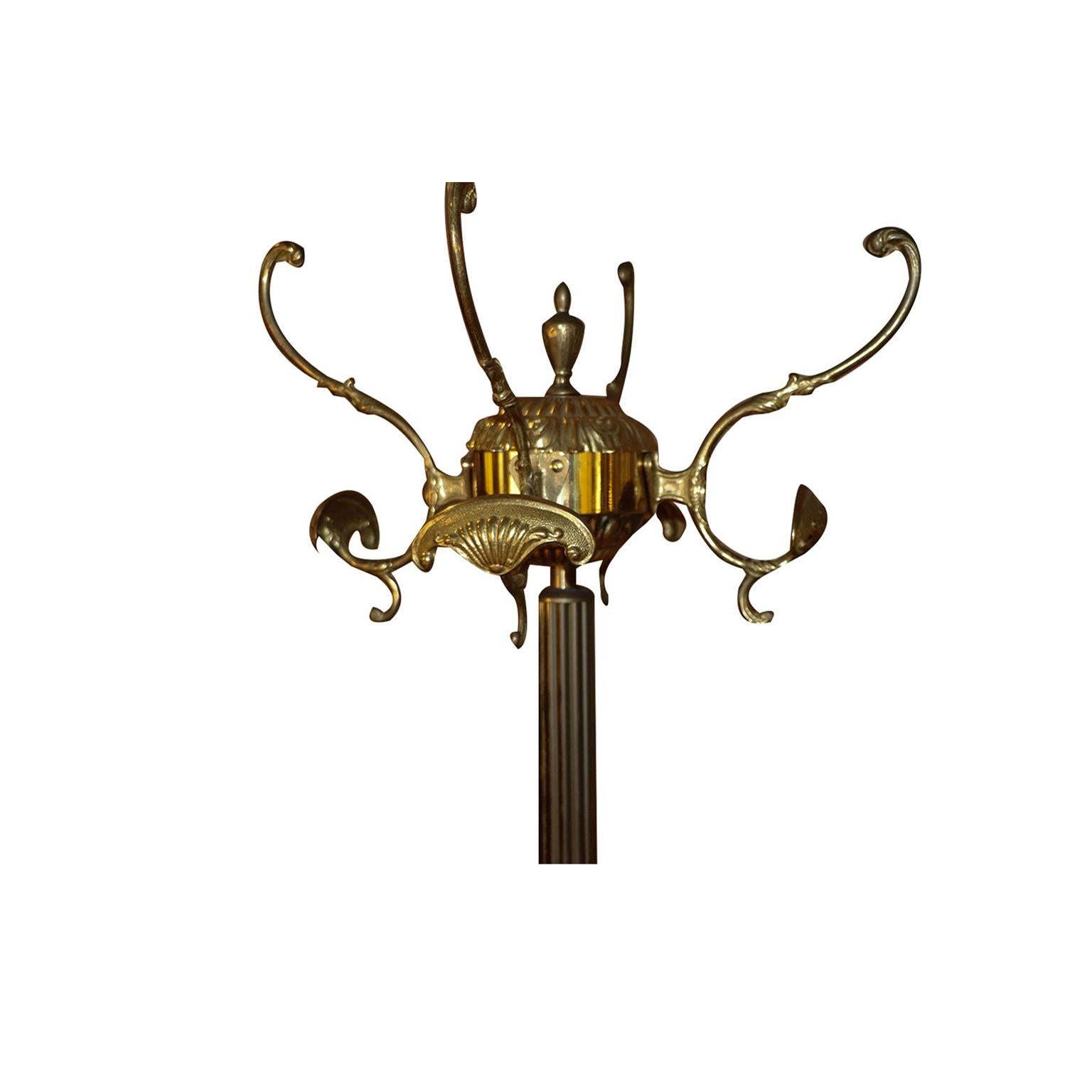 A beautiful solid brass vintage ornate French Lion hall tree, coat/hat stand. The brass body of this stand is well designed and thoughtfully crafted. Features a molded brass top which turns 360 degrees, the four sturdy coat hooks surround the brass
