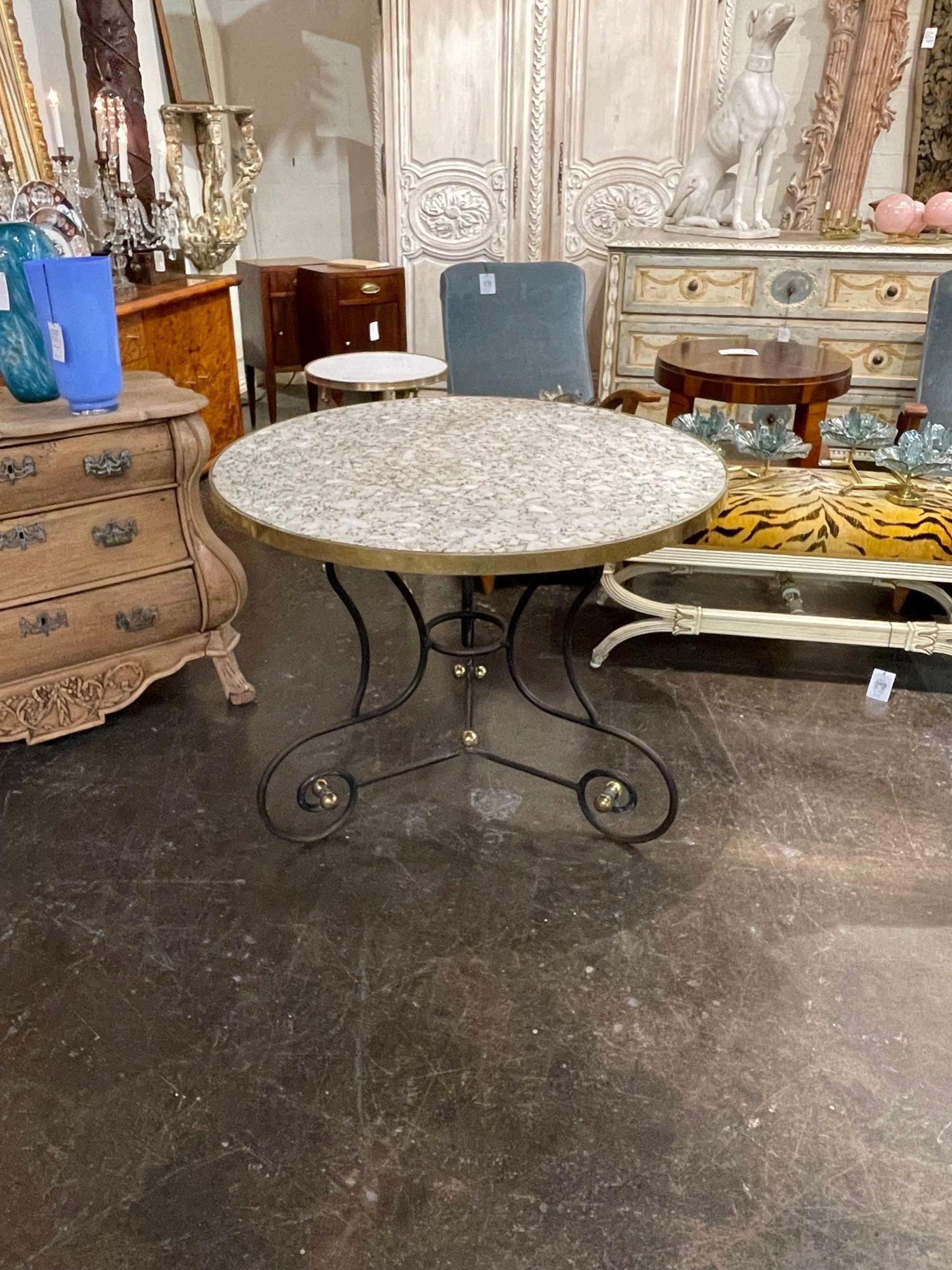 Handsome vintage French steel and brass bistro table with a granite top. Mixes well with a variety of decors.  This piece would be great on the patio.  Really! nice!
