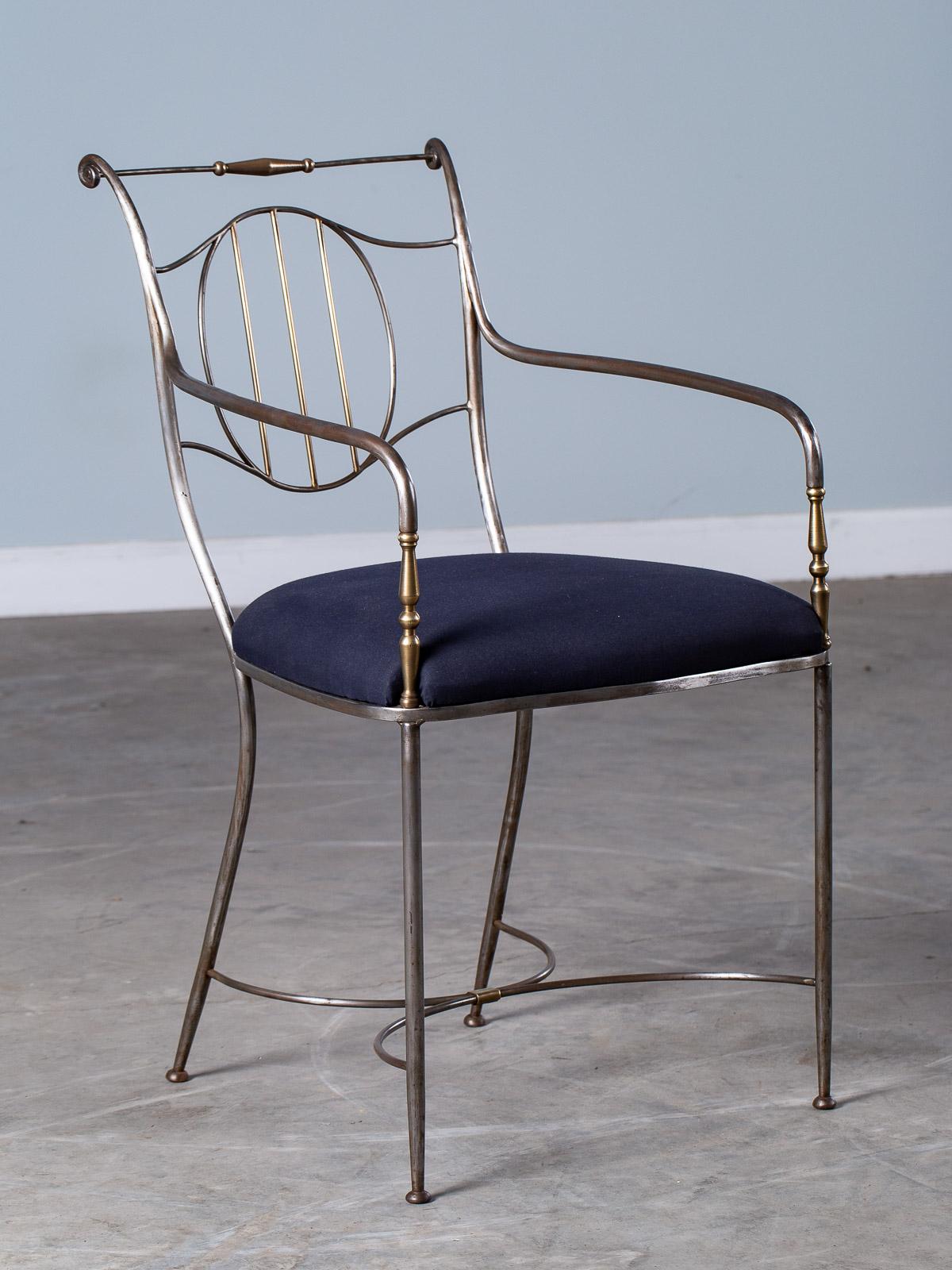 A stylish vintage French steel and brass chair, circa 1940 with an upholstered seat. The wonderful sweep of the curved lines gives this chair its modern and contemporary quality. Modeled after chairs made two centuries ago this vintage steel chair