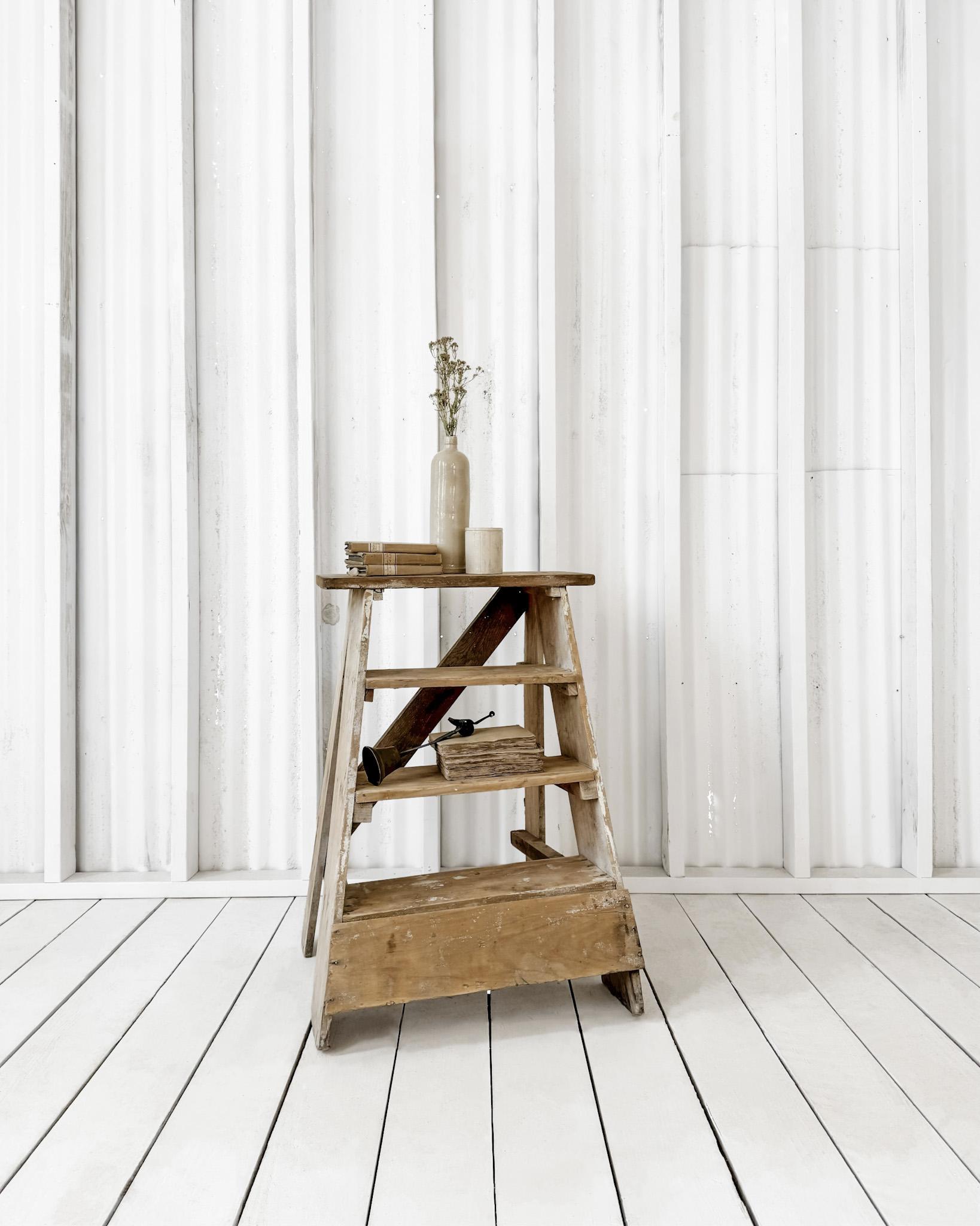 Sturdy and functional, this old handmade step stool would make a unique side table. 4 steps provide ample space to stow books and collectibles. Whether used in a bedroom or living room, its patinated bleached appearance and handsome lines make it a