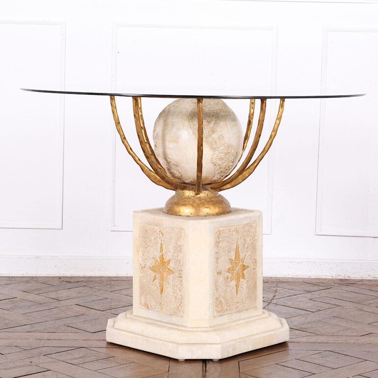Vintage French ‘globe’ table with a metal and onyx base and a removable round glass top. The square base rests on a plinth support and features a carved compass on each side. Above is a gilded hemispherical frame around an onyx globe with a round