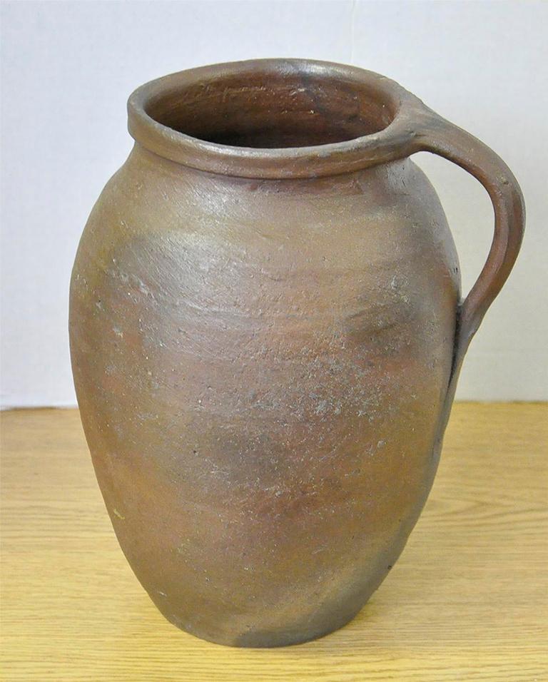 Vintage French stoneware jug from the Brittany region of France. Handmade and unglazed. These jugs were used on the dairy and apple farms. Beautiful color variation from the firing process.