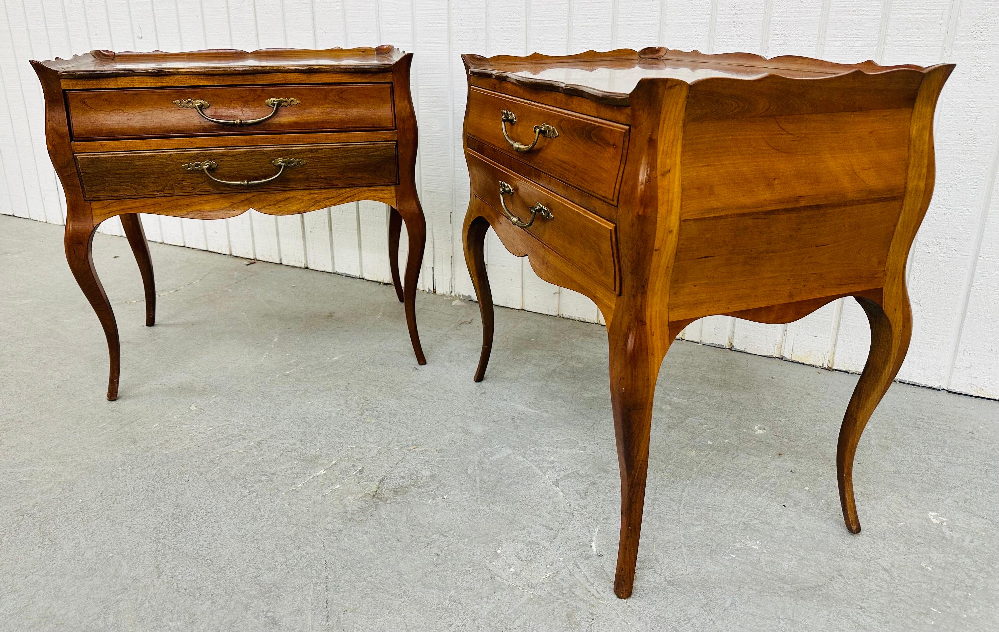 This listing is for a pair of vintage French Style Cherry Wood Nightstands. Featuring a French style design, two drawers for storage, original brass pulls, and a beautiful cherry finish. This is an exceptional combination of quality and design!