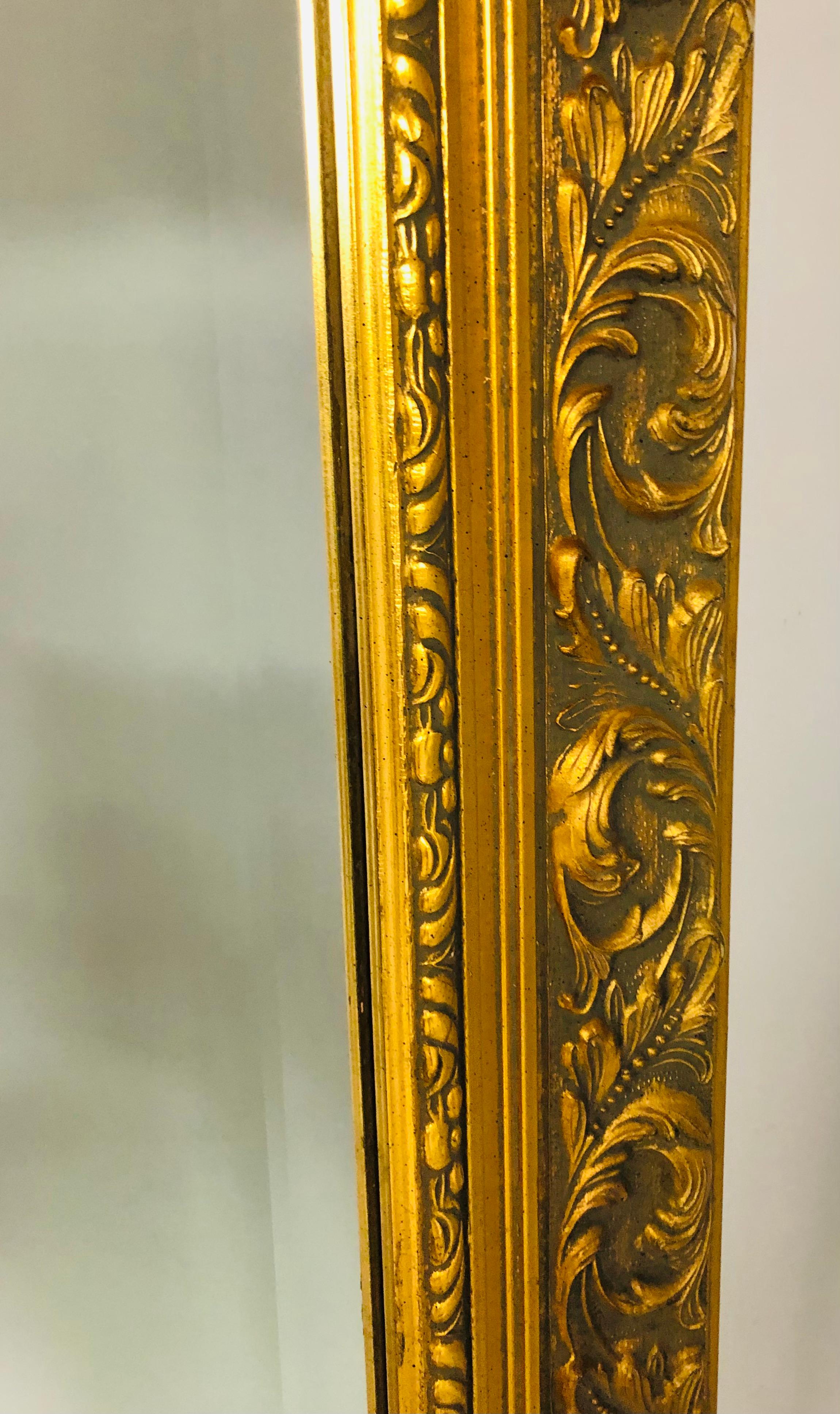 A Large vintage French Style Gilt wood mantel, pier or console large Mirror. The Frame is finely carved showing beautiful leaves pattern. The mirror glass is beveled. The mirror is sturdy and high quality. The gilt wood in good condition. 
The