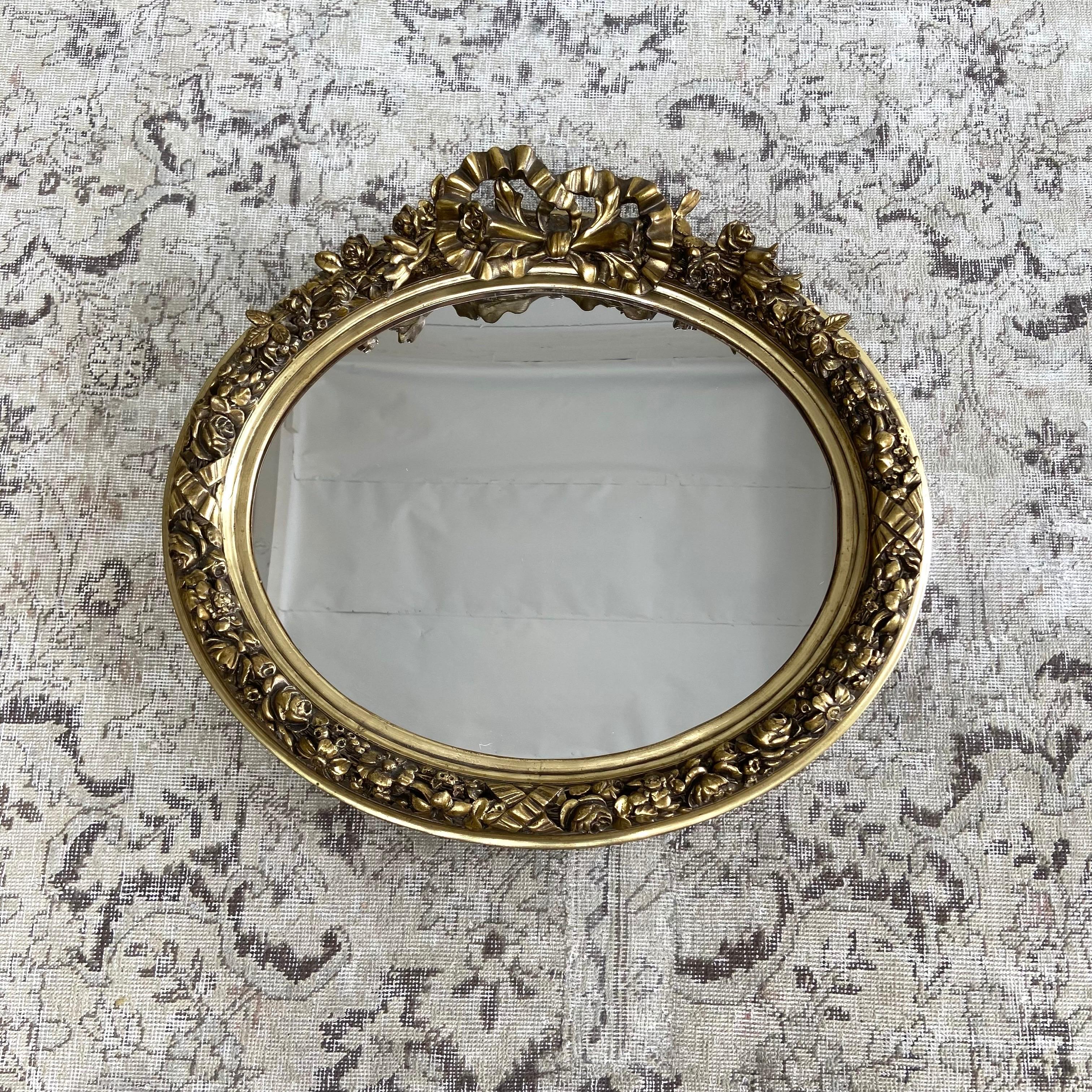 Vintage Style French Gilt wood wall mirror with ribbon and roses.
Please see quantity availability. 
Mirror is new condition, with no flaws.
Size:28”w x 25”h.
