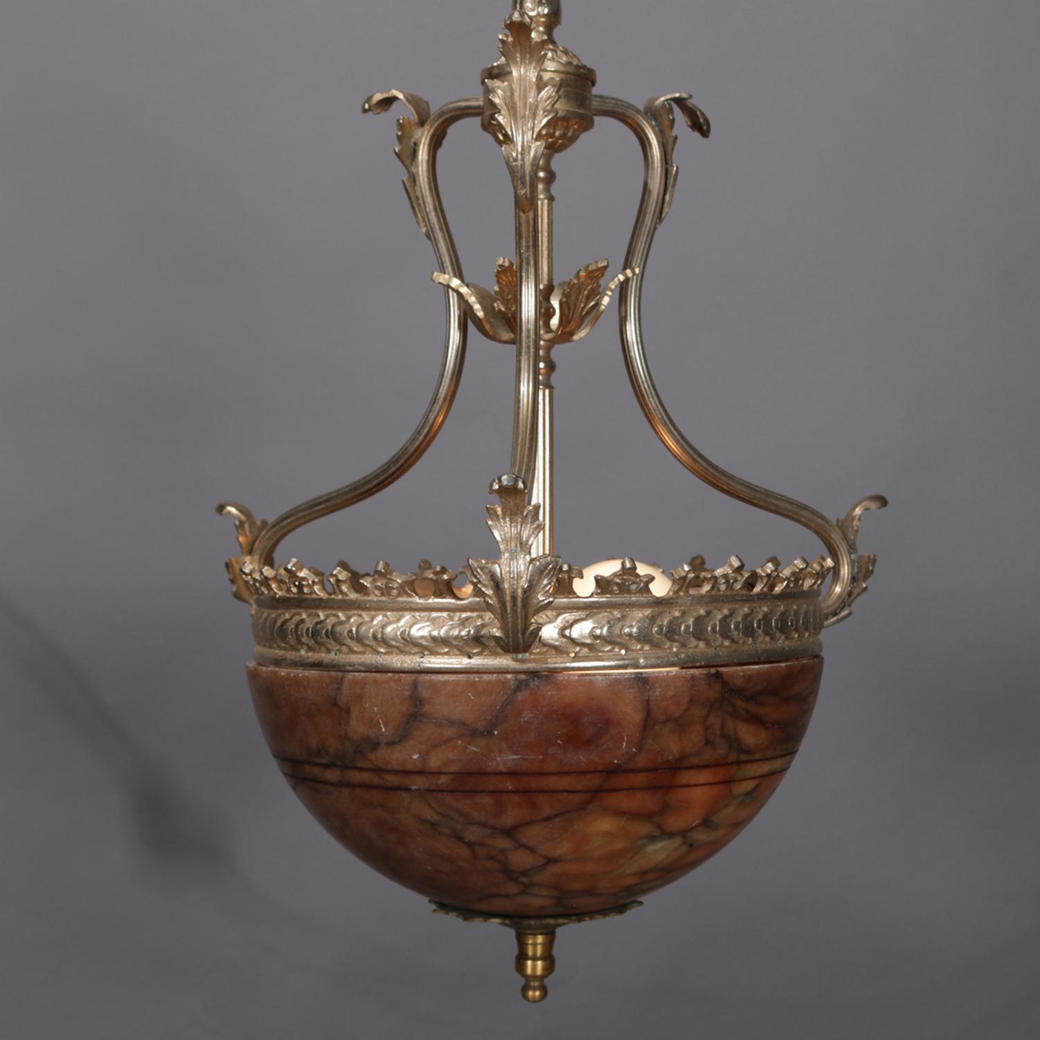 A vintage French style pendant light features gilt bronze crown form frame with foliate attachments and supporting marble bowl, professionally rewired and working, circa 1930.

Measures: 37