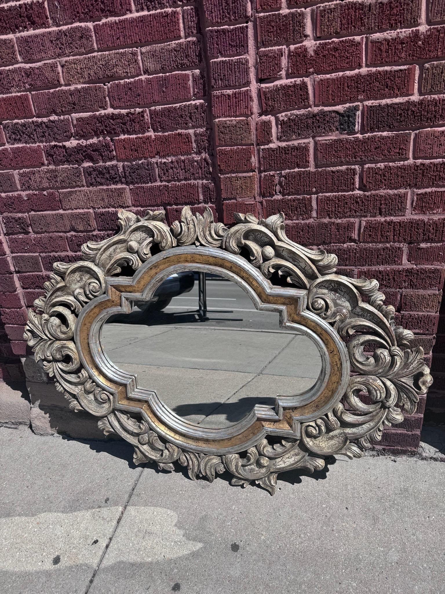 Vintage French Style Ornate Carved Wall Mirror by John Richard

Add a touch of timeless elegance to your home with the Vintage French Style Ornate Carved Wall Mirror by John Richard. This exquisite mirror features intricate scroll work and ornate