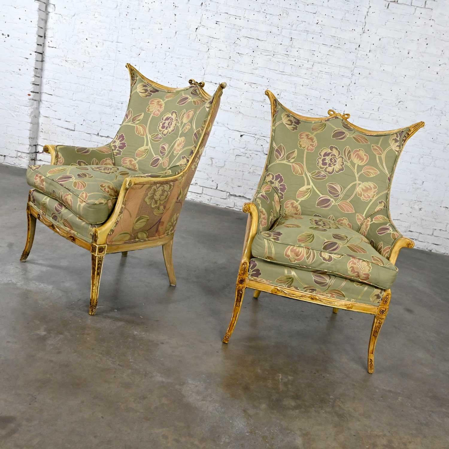 Gorgeous pair of vintage French style armchairs with distressed painted finish frames, carved details, down filled seat cushions, & reupholstered in a taupe & floral fabric with a purple & rose hue. Beautiful condition, keeping in mind that these