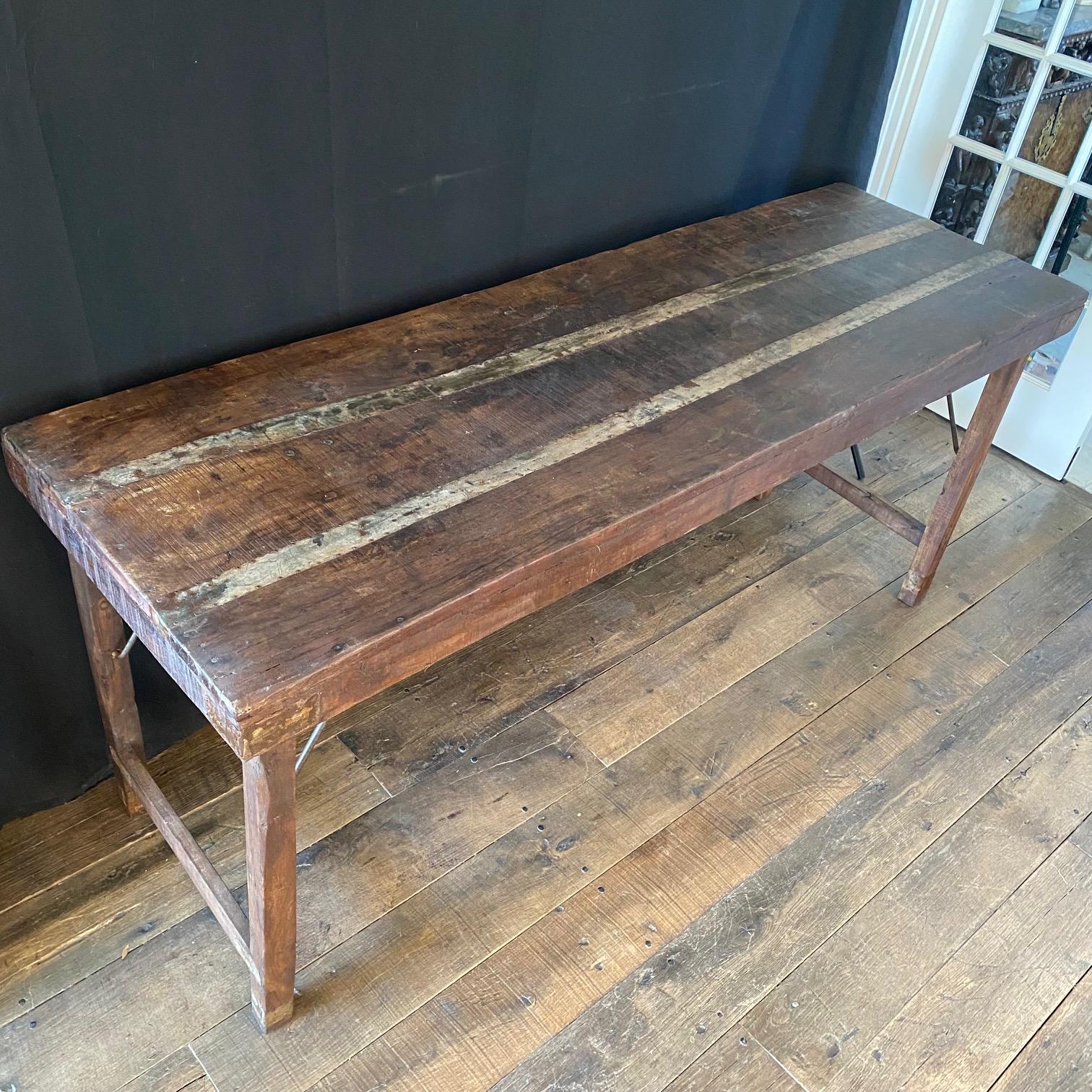 An early rustic folding table, hardwood with iron strapping, used by tradesman possibly for paper hanging. Table folds up making it easy to transport to projects. Use this table for a console table, sofa table, dining table, work table or serving