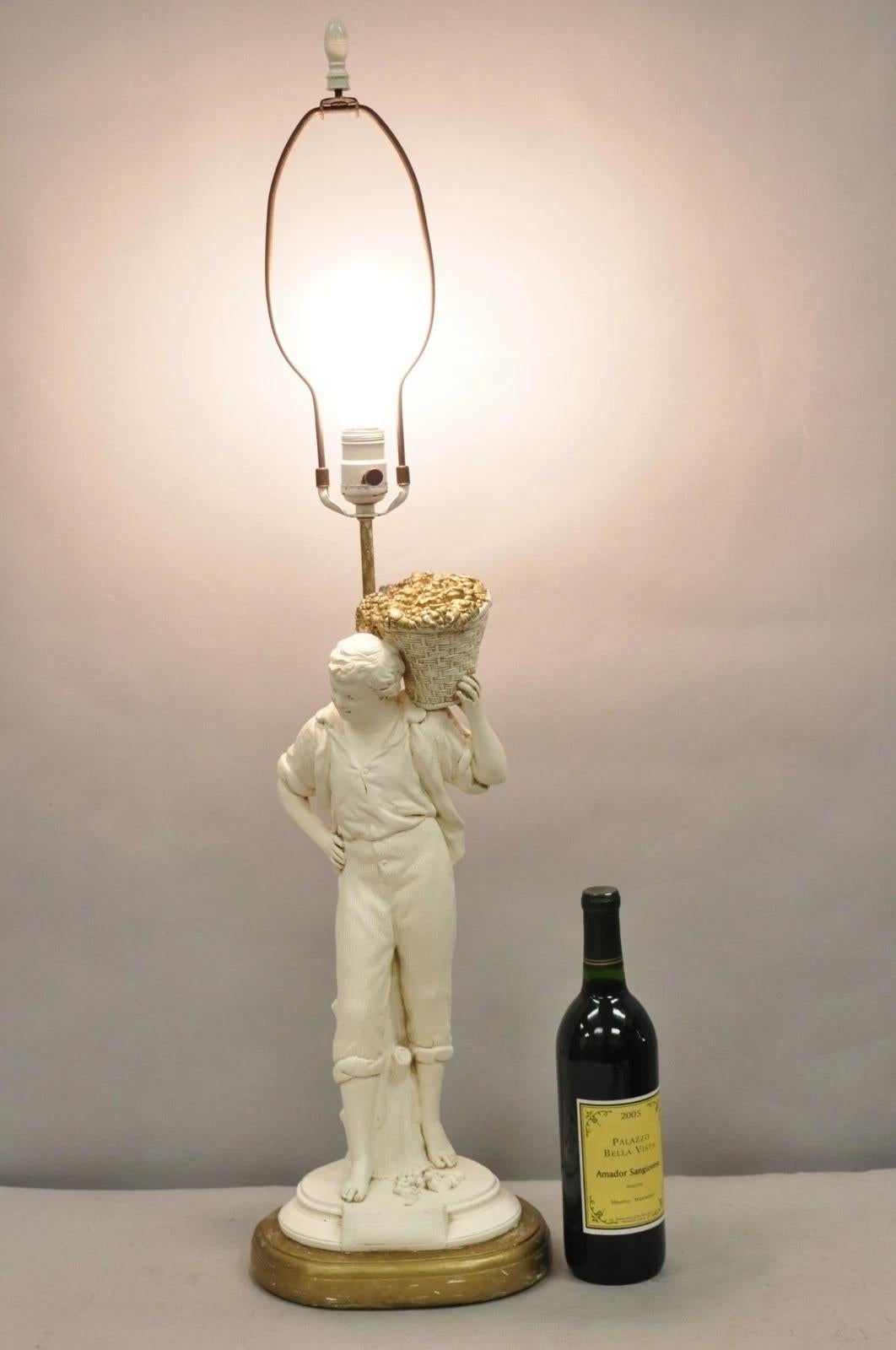 Vintage French Renaissance Style White & Gold Distress Painted Metal Figural Boy w Flower Basket Table Lamp by Quartite. Circa Mid 20th Century. Measurements: 37