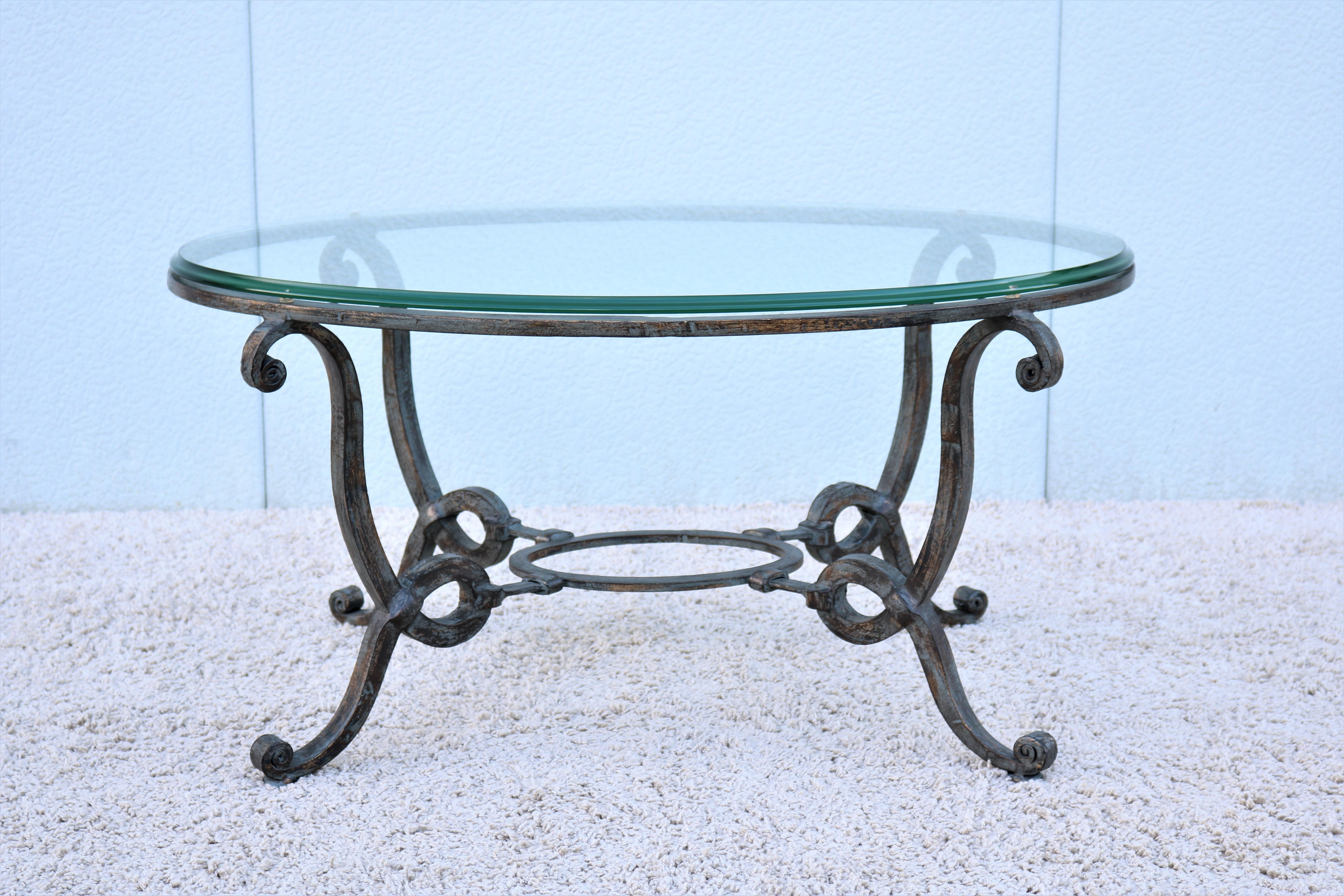 Gorgeous 1980s French wrought iron oval coffee table with beveled glass top.
Features a hand forged iron base with classic scrolls and rust distressed finish.
The French design brings charming historic Old-World elements into your room.

Dimensions: