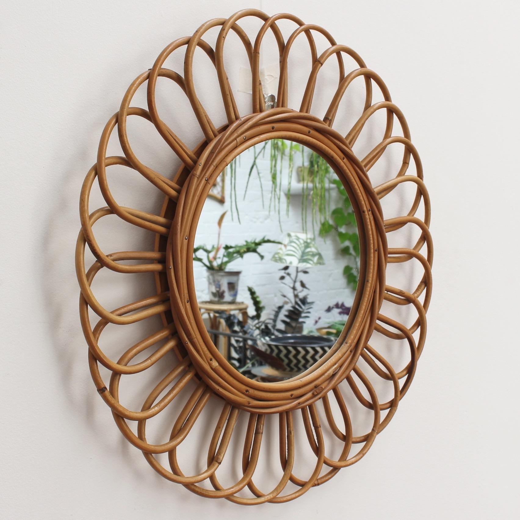 Vintage French sunflower-shaped rattan wall mirror (circa 1960s). Cheerful, stylish and very collectible, the mirror will transport you to another era on the French Riviera. It has loads of character and charm and is in good vintage condition