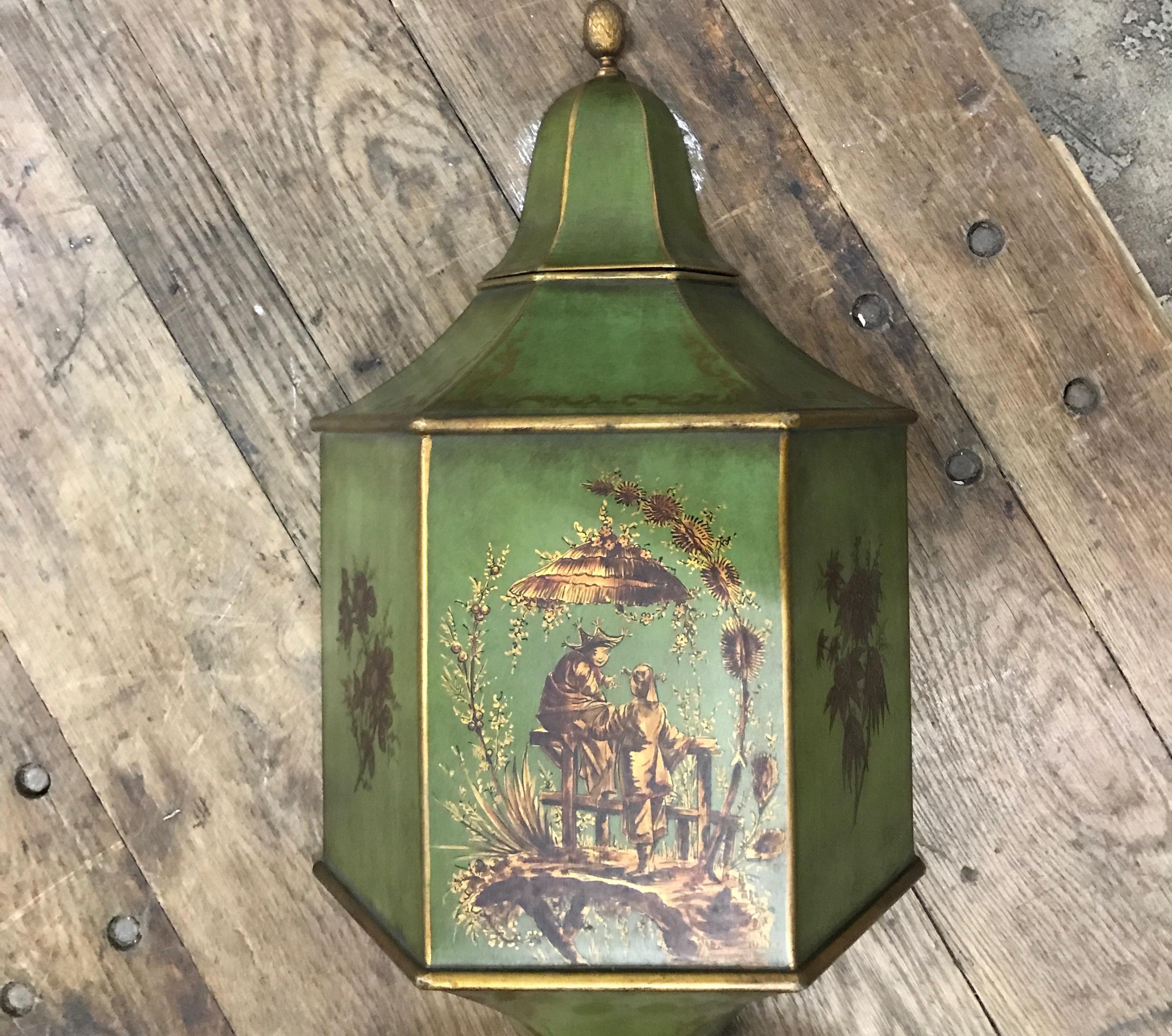 Very decorative chinoiserie tole lavabo. Beautifully hand painted lavabo with a lush green background with brown and gold details. Top lid is finished with an acorn.