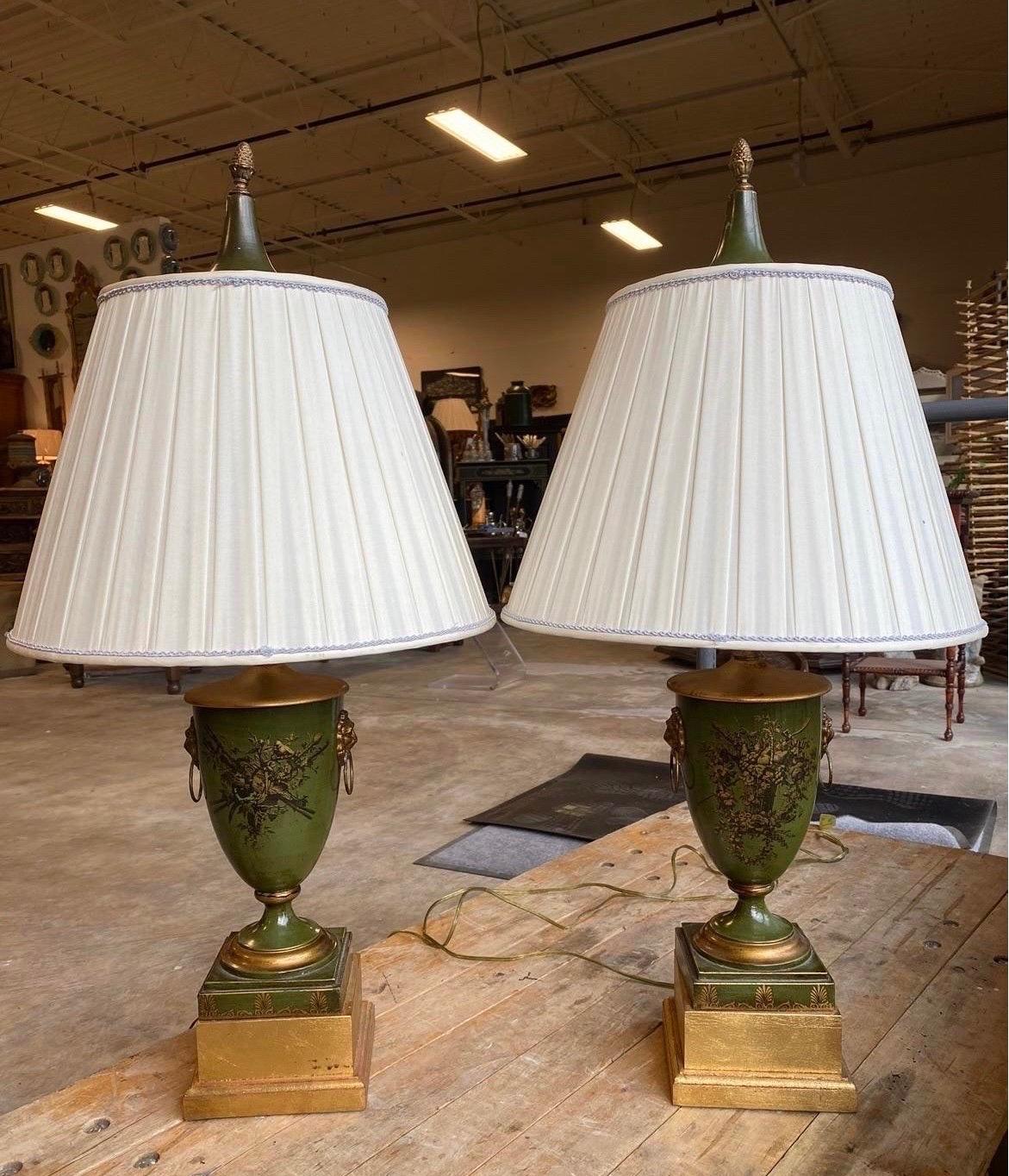Pair, antique or vintage french green tole hunting urns which have been converted into table lamps. Retain original lids which now rest on the top of shades over the finials.