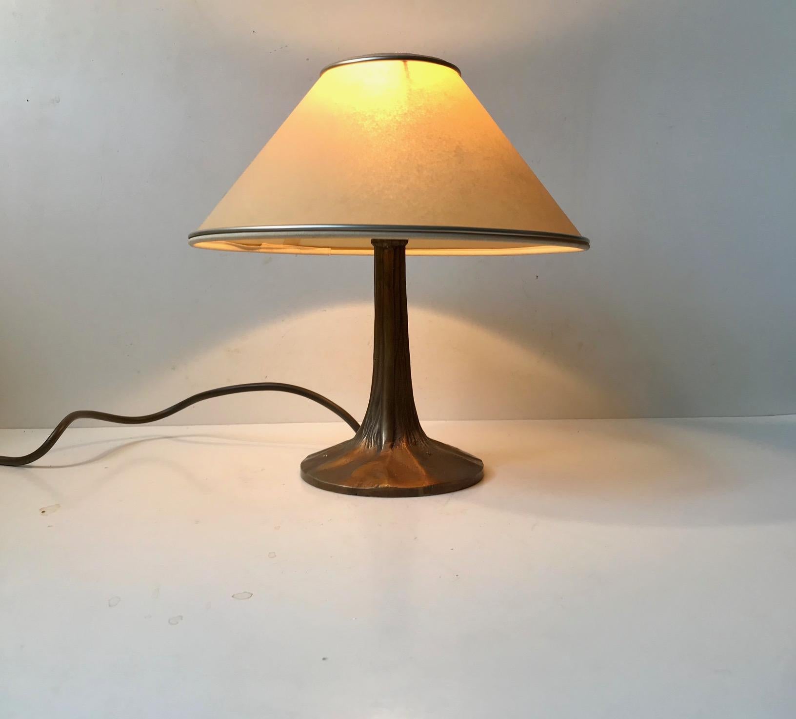Small unusual French table lamp with tree trunk shaped base in bronze. It was made during the 1940s or 1950s and it has a vintage textile shade that matches.