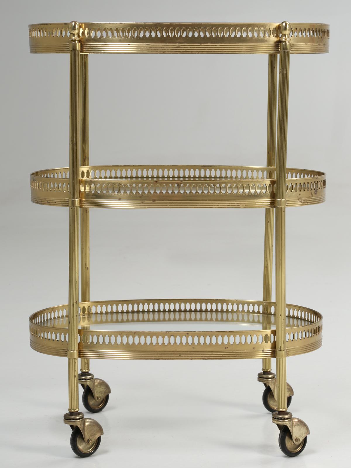 Vintage French très petite brass bar cart or tea cart in its original finish. Please note some minor imperfections or pitting in the brass plating.