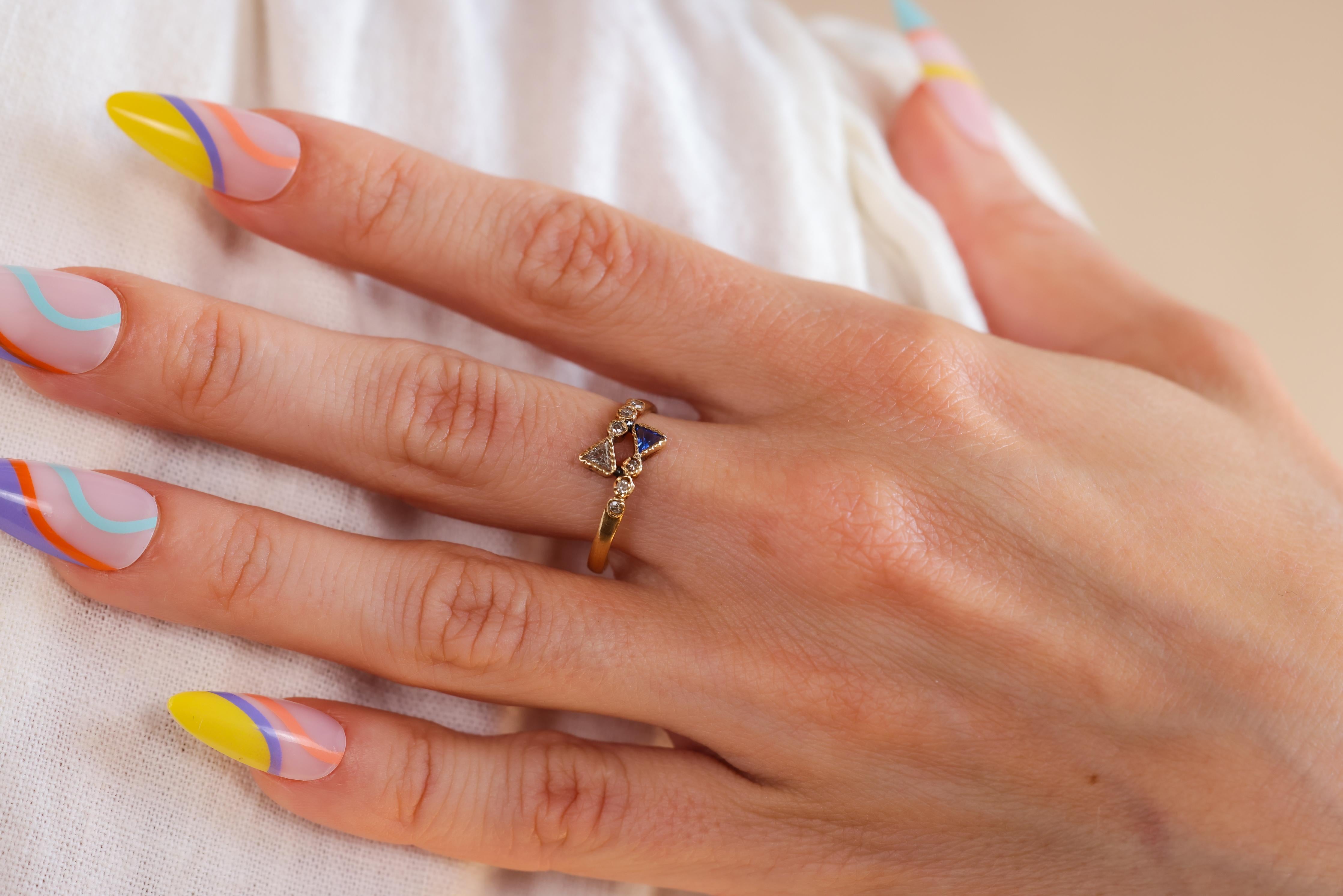 Center Stone: 7 Diamonds
Cut: Trillion and Single
Weight: Approximately 0.25 Carat
Color: K-L
Clarity: SI
Center Stone: Sapphire
Cut: Trillion
Weight: Approximately 0.20 Carats
Metal: 18K Yellow Gold
Era: Mid Century
Circa: 1960's
Hallmarks: French
