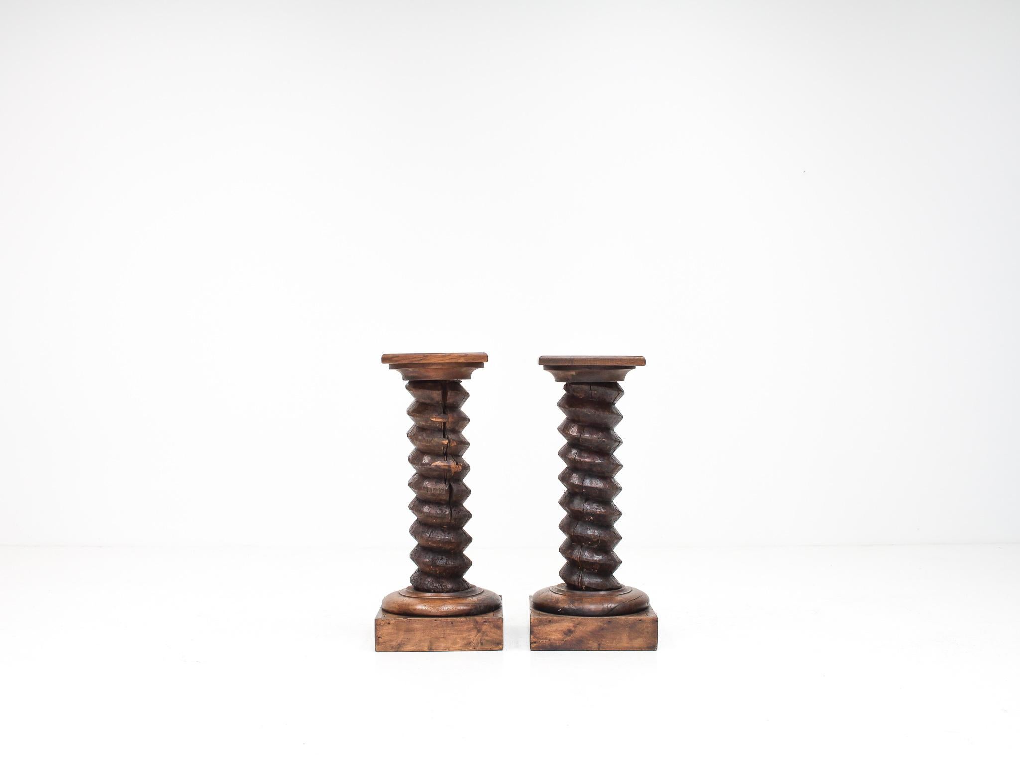 A pair of French pedestal plinths with a turned column stem, reminiscent of Charles Dudouyt designs.

Plinth form most probably dates from the early-Mid 20th Century with the turned screw columns from a much earlier date and most probably used as