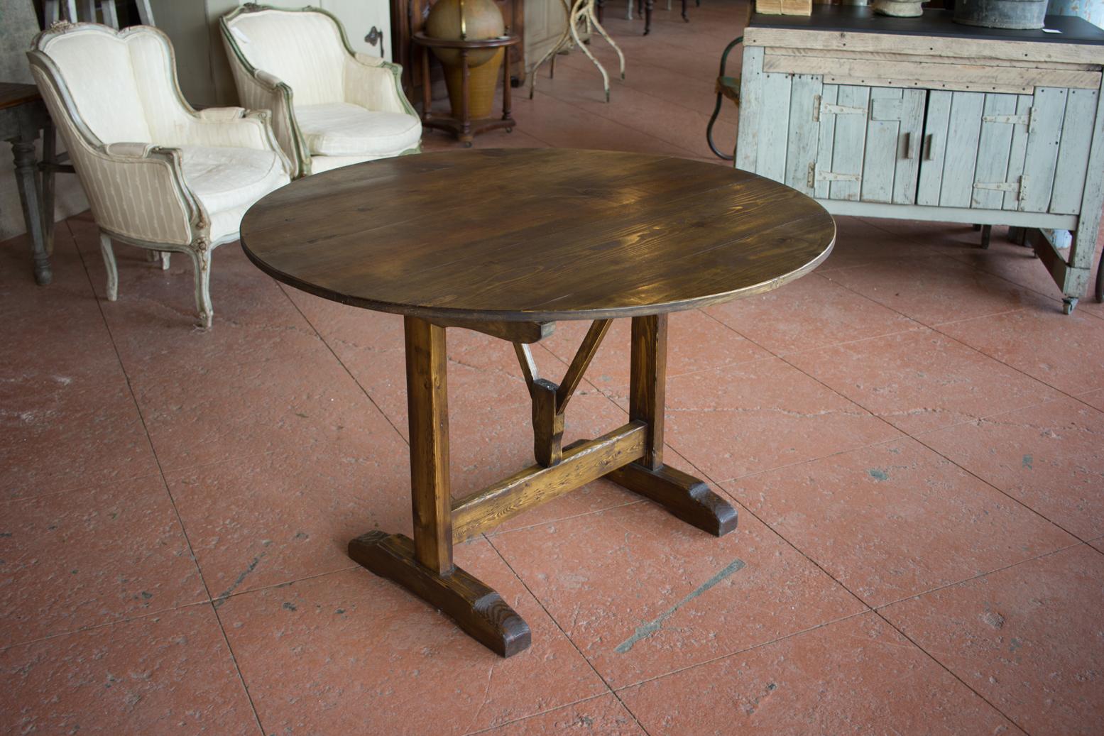 Vintage vendange tilt-top table. Originally these tables were used at a vineyard for testing and tasting the produced wine. It’s a usable storable table that can be used inside or outside for al fresco dining.
    