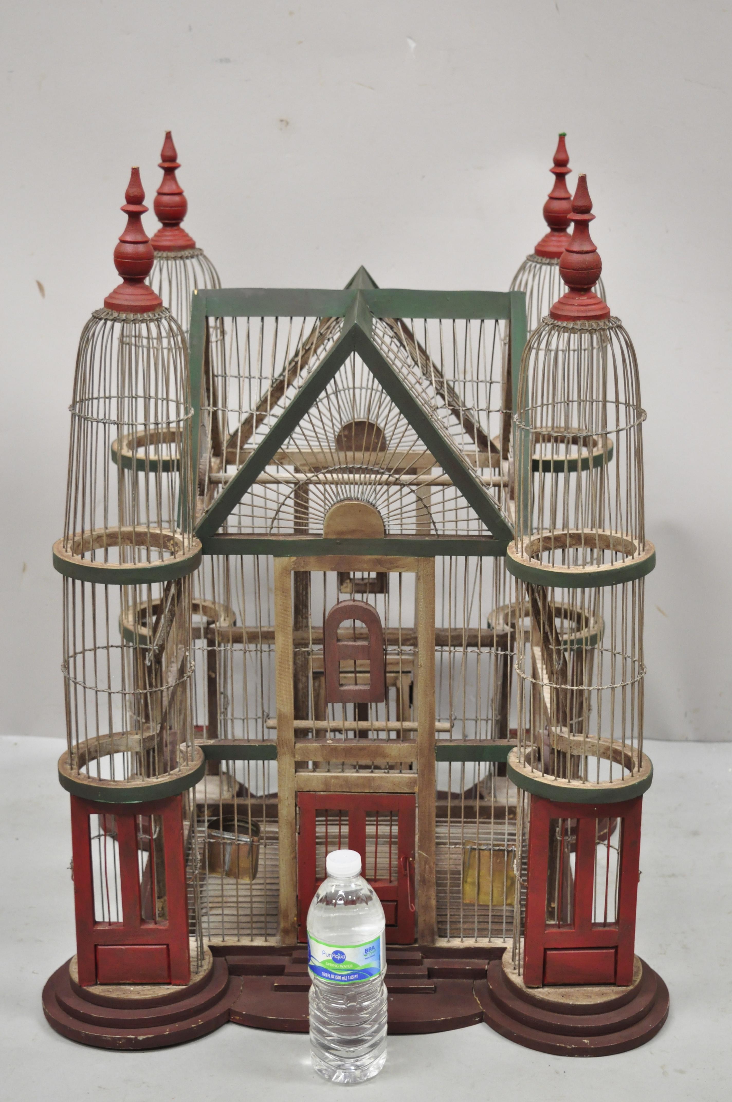 Vintage French Victorian large wooden antique painted cathedral domed birdcage. Item features entry from both sides, green and red painted finish, carved finials, bird swing on the inside, solid wood frame, very nice vintage item, quality