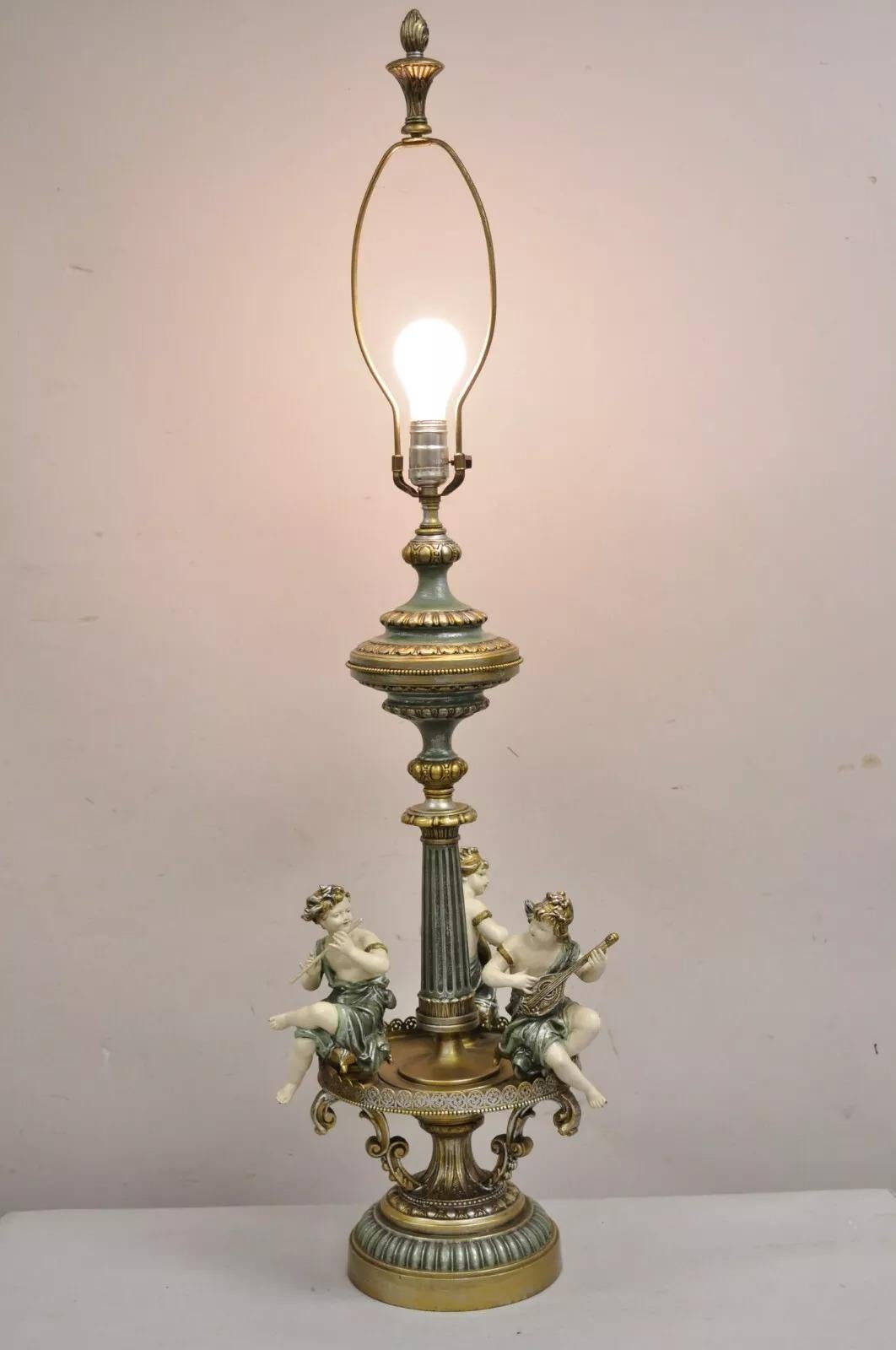 Vintage French Victorian Renaissance Figural Triple Cherub Musician Metal Table Lamp with Blue/Green and Gold Distress Painted Finish. Circa Mid 20th Century. Measurements: 43.5