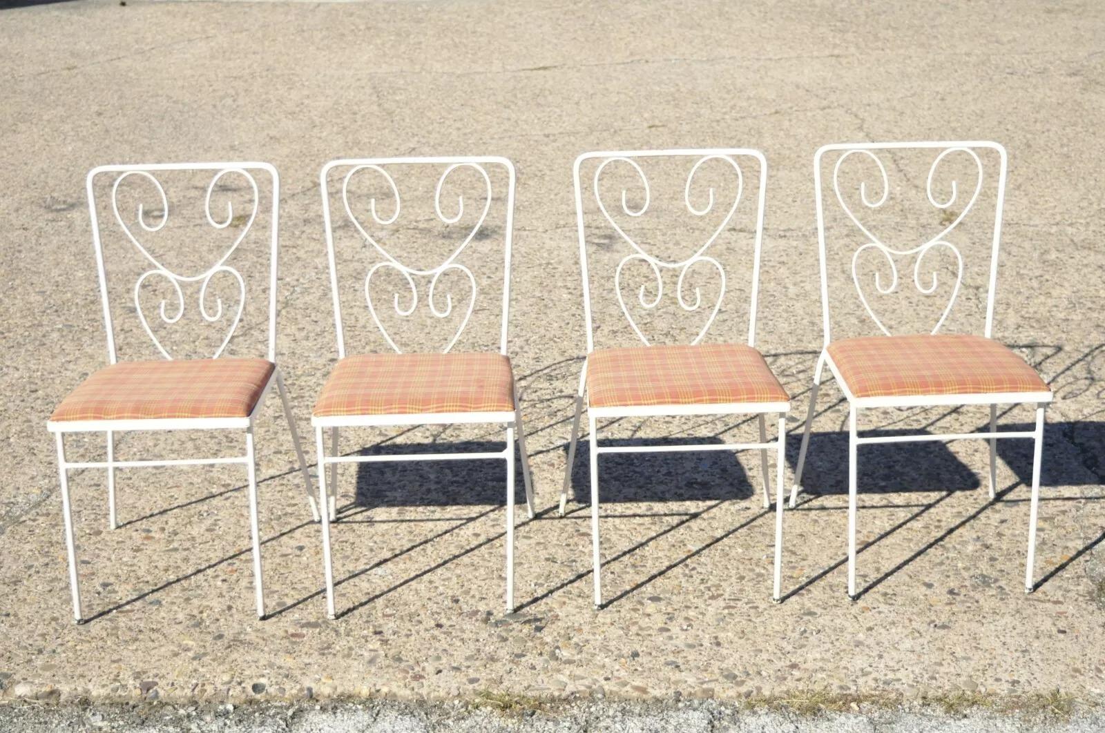 Vintage French Victorian Style Wrought Iron Flower Garden Patio Dining Set - 5 Piece Set. Item features (4) chairs, (1) glass top table, flower backs, wrought iron construction, very nice vintage set, great style and form. Circa Mid 20th Century.