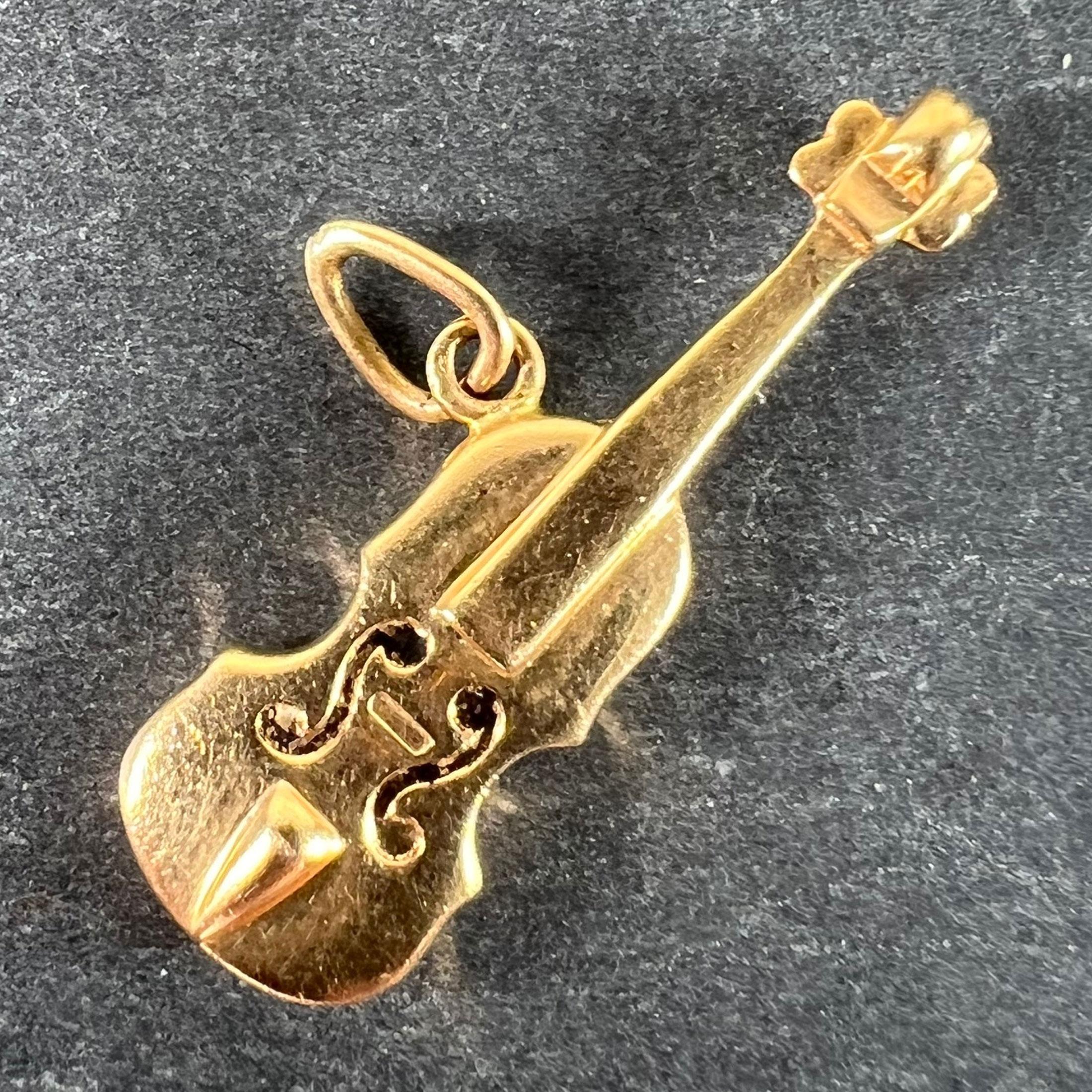 A vintage 18 karat (18K) yellow gold charm pendant designed as a violin with traces of black enamel to the scroll details. Stamped with the eagle's head for French manufacture and 18 karat gold.
 
Dimensions: 2.6 x 1 x 0.41 cm
Weight: 1.57