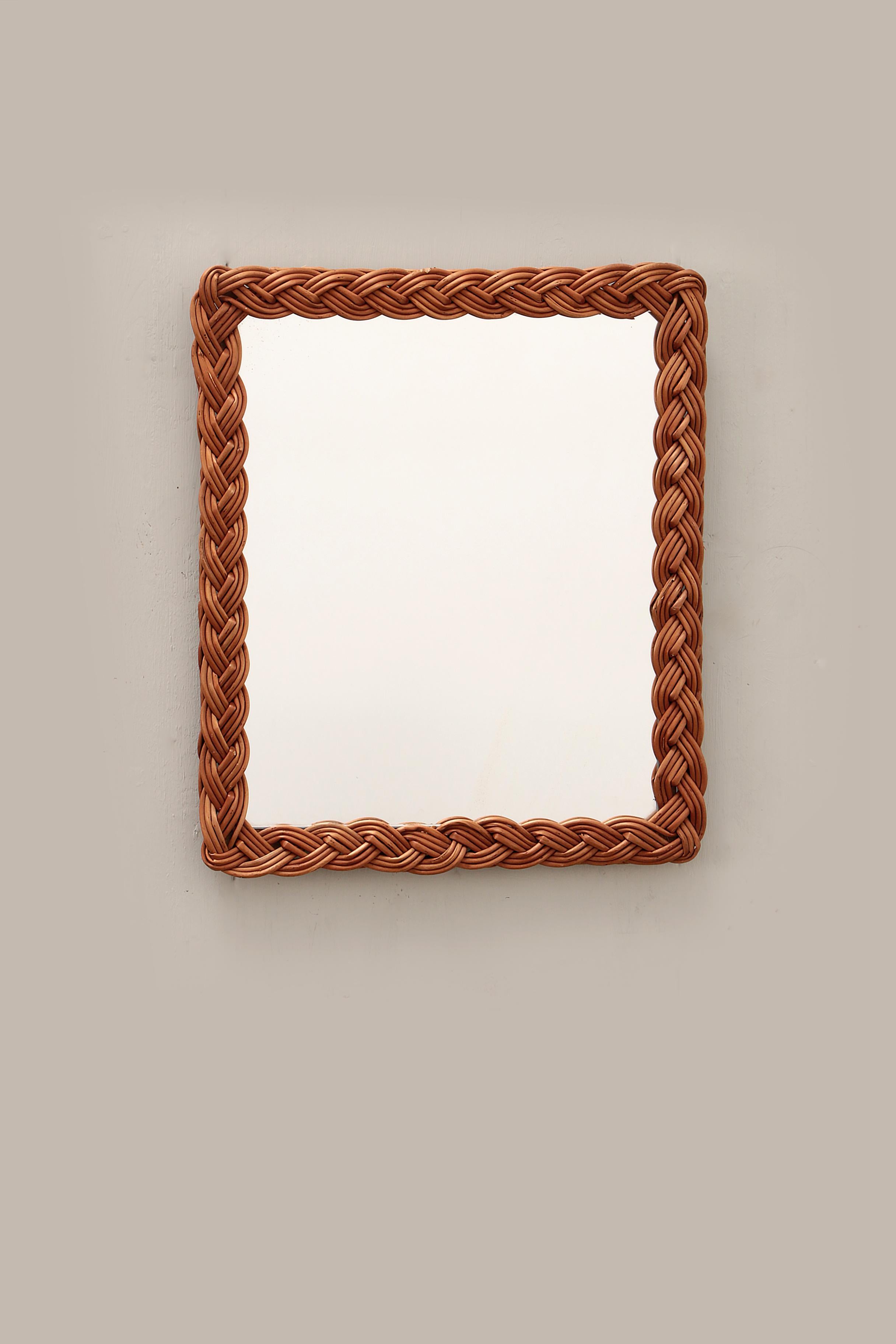 Midcentury decorative mirror with curved rattan frame.

This mirror was made around 1960 with a beautiful patina.

This beautiful item was made in France in the 1960s. The design and materials let you feel the atmosphere and breeze of the French