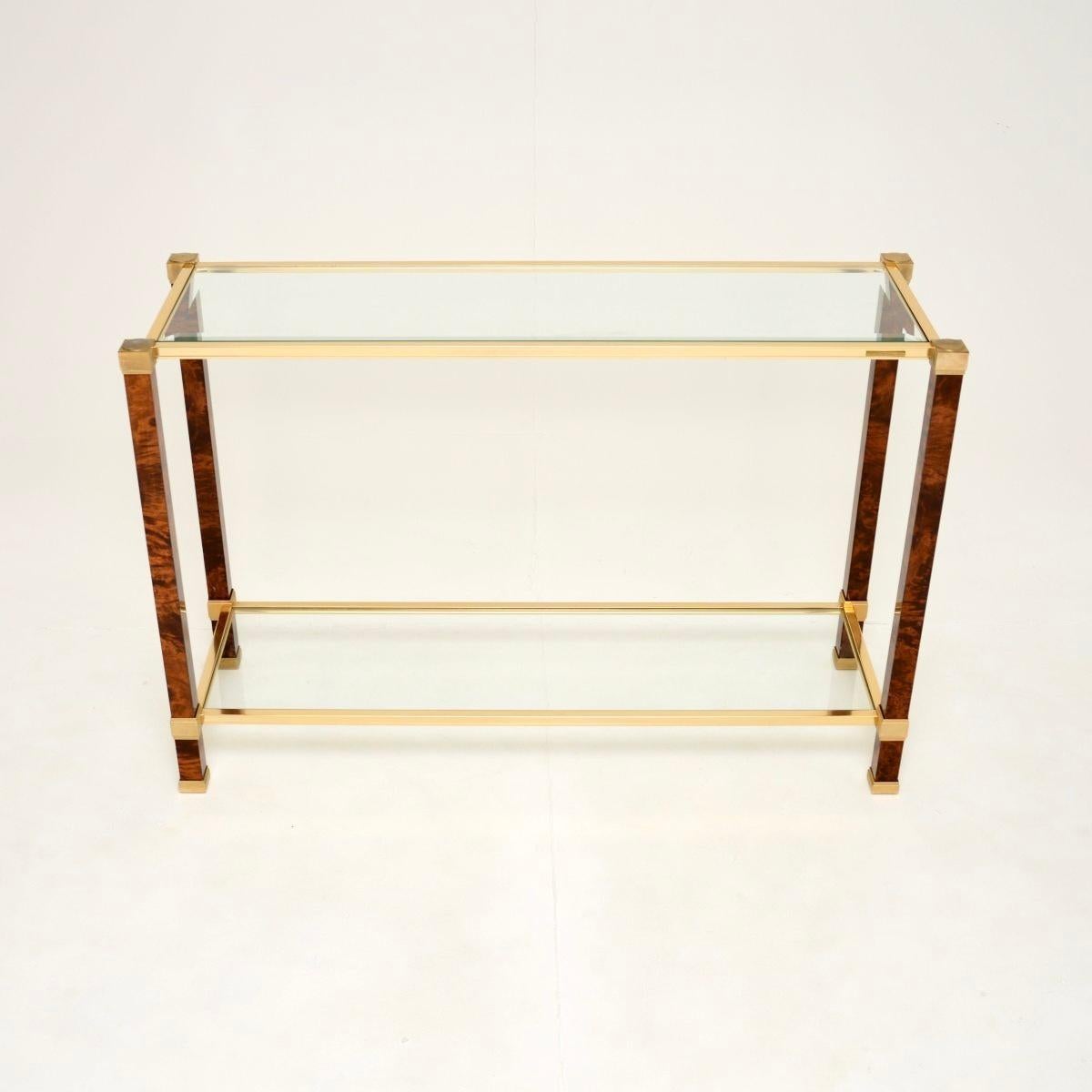 A stunning vintage French walnut and brass console table by Pierre Vandel Paris. This was made in France, it dates from the 1970’s.

It is of lovely quality with a beautiful design, the lacquered burr walnut frame has amazing grain patterns and a