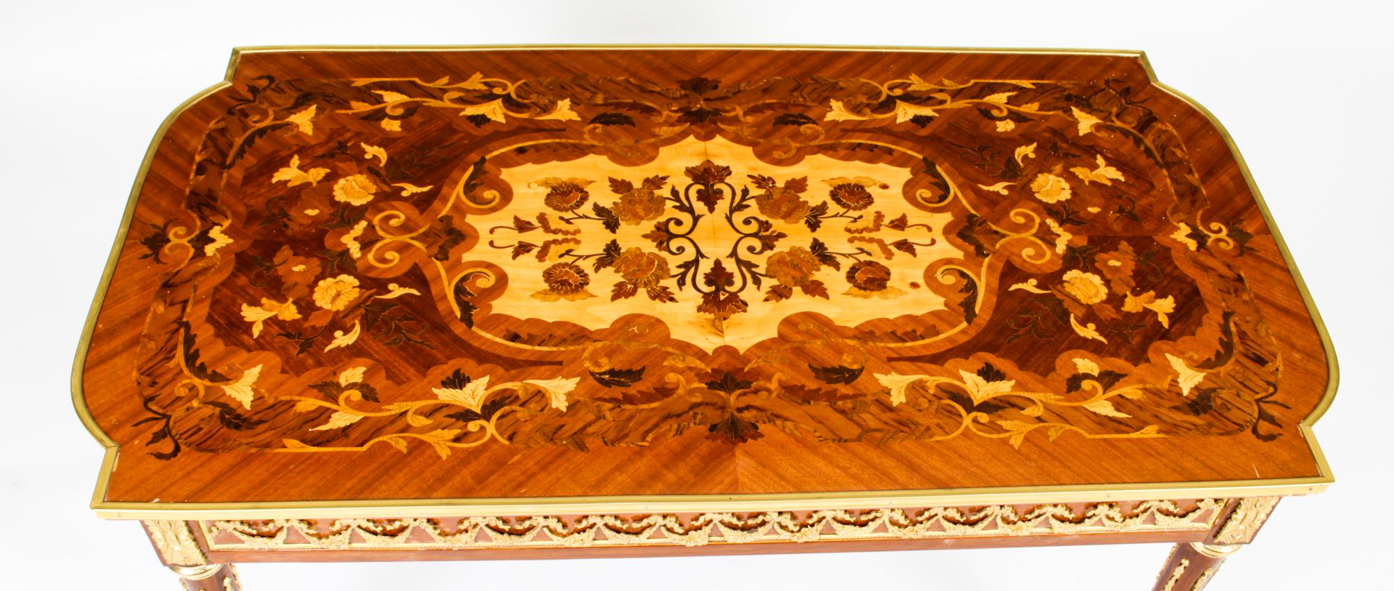 This is a stunningly beautiful Vintage French marquetry burr walnut coffee table, masterfully inlaid with multi-coloured exotic decorative floral inlays by a master craftsman and late 20th C in date.

The table’s breathtaking inlays set against