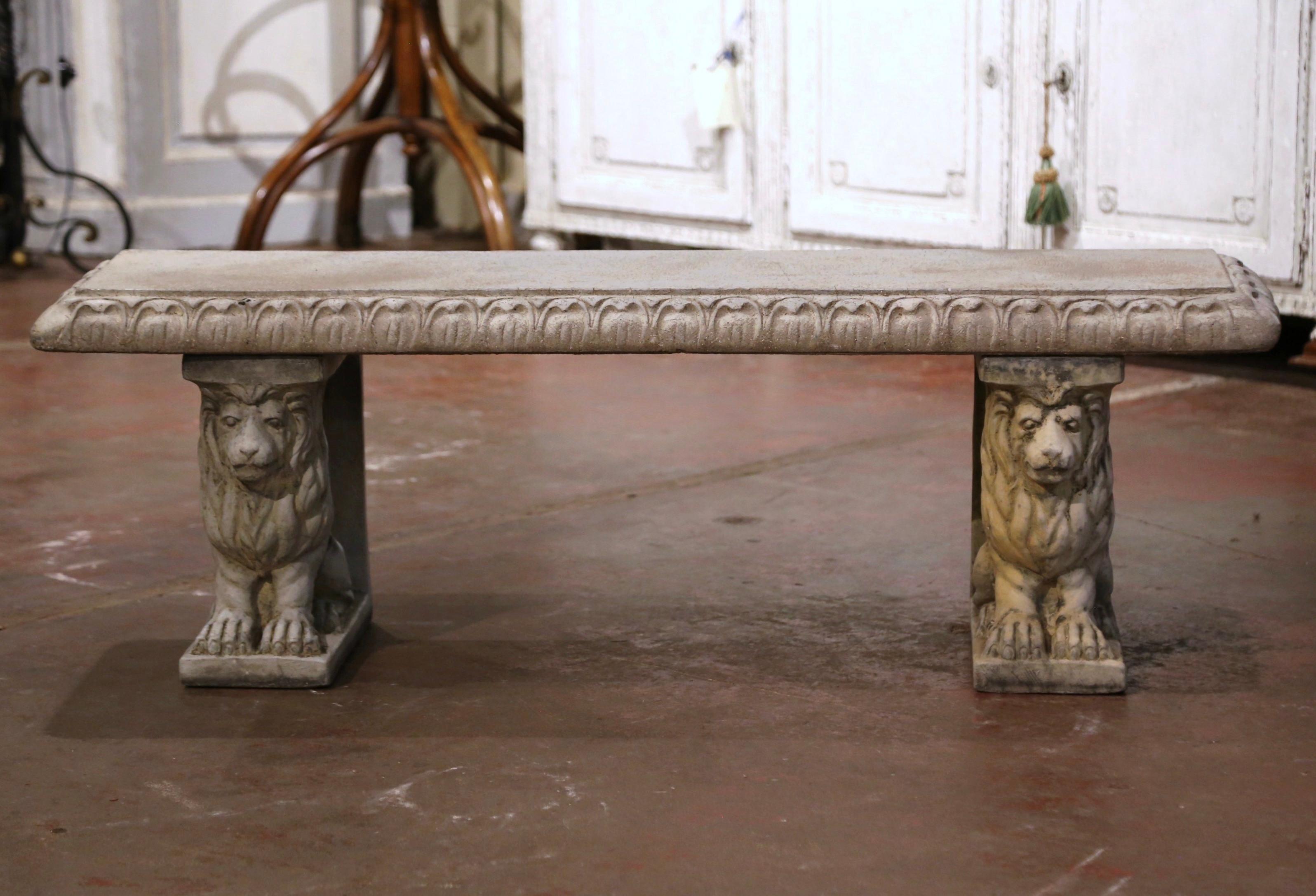 Decorate a garden or a patio with this elegant bench. Crafted in France, circa 1980, the concrete bench stands on two lion figures pedestal bases over a long rectangular seat decorated with geometric motifs along the edges. The rustic seating is in