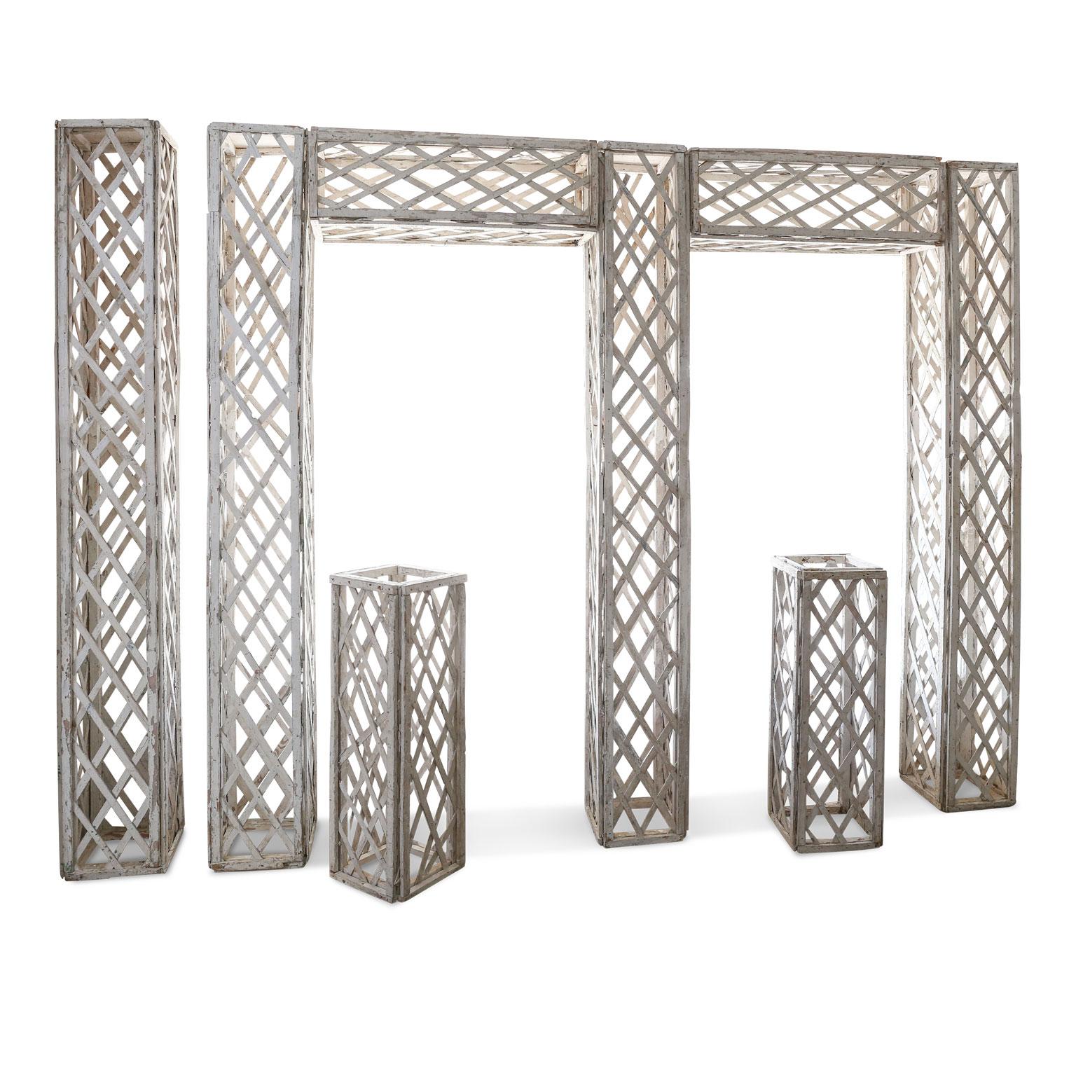 Vintage French white painted trellis (circa 1940) from a garden near Versailles. White painted wooden trellis is composed of eight sections which may be easily disassembled and recombined together into different formations or structures. Four