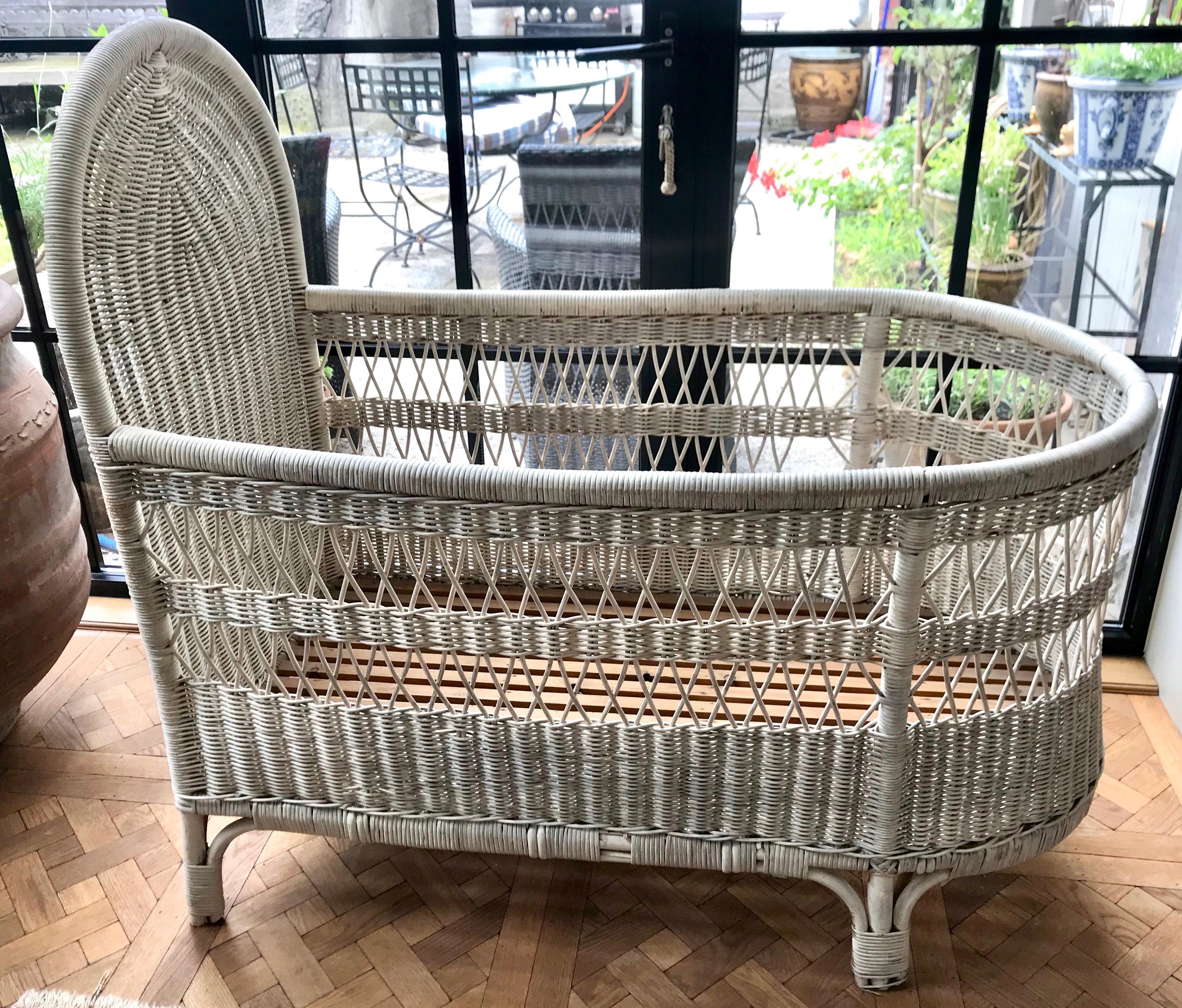 French wicker baby bed/ crib. Safe to use for a baby since there are no large spaces, but as with all cribs a bumper pad should be used (standard size will fit) 
There are some small missing pieces as shown in the photos, and it is not painted on