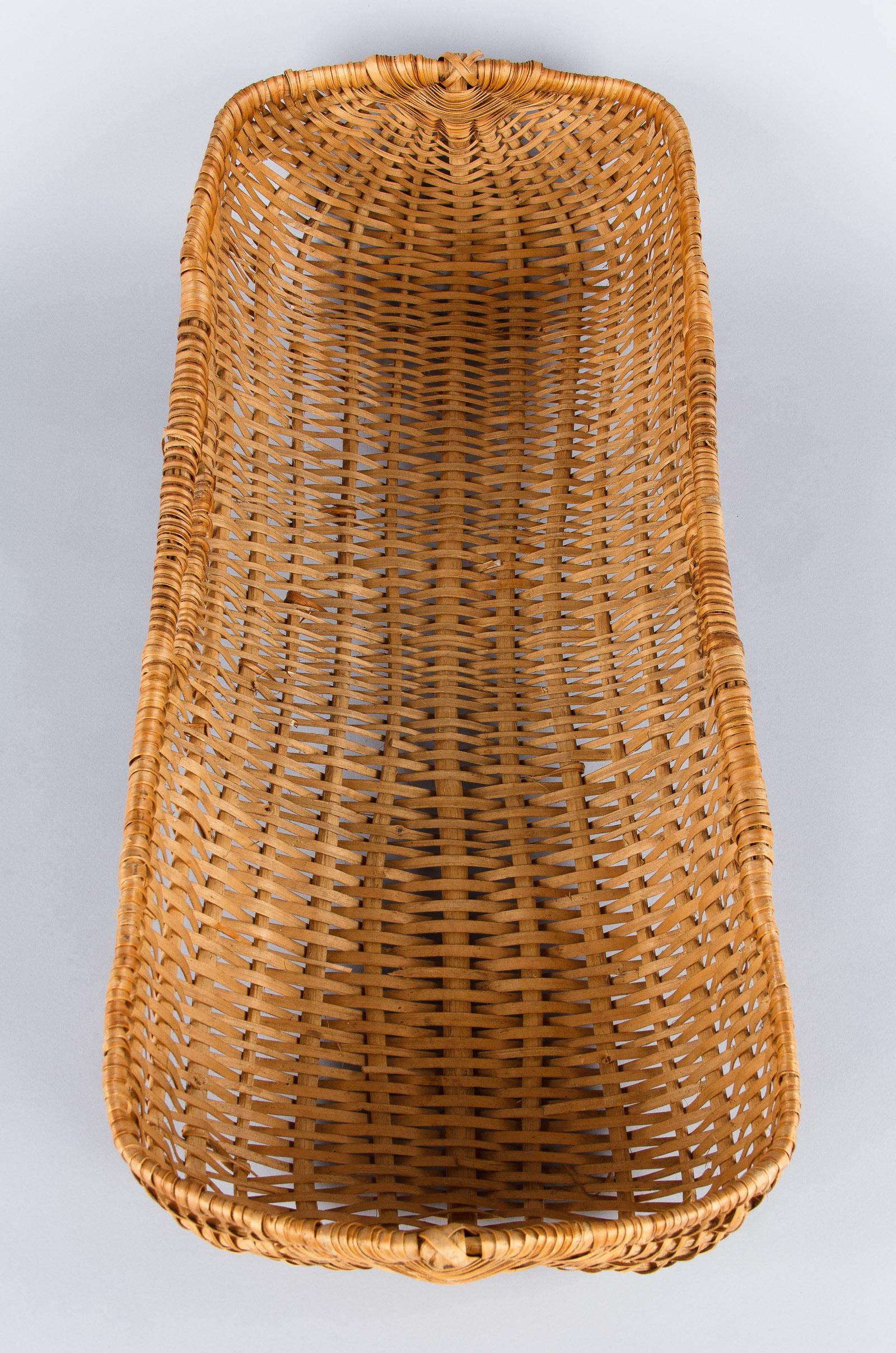 An unusual flat wicker basket with 2 side handles from the Auvergne region in central France. This type of basket was used in French farmers' markets to display fruits, vegetables or flowers.