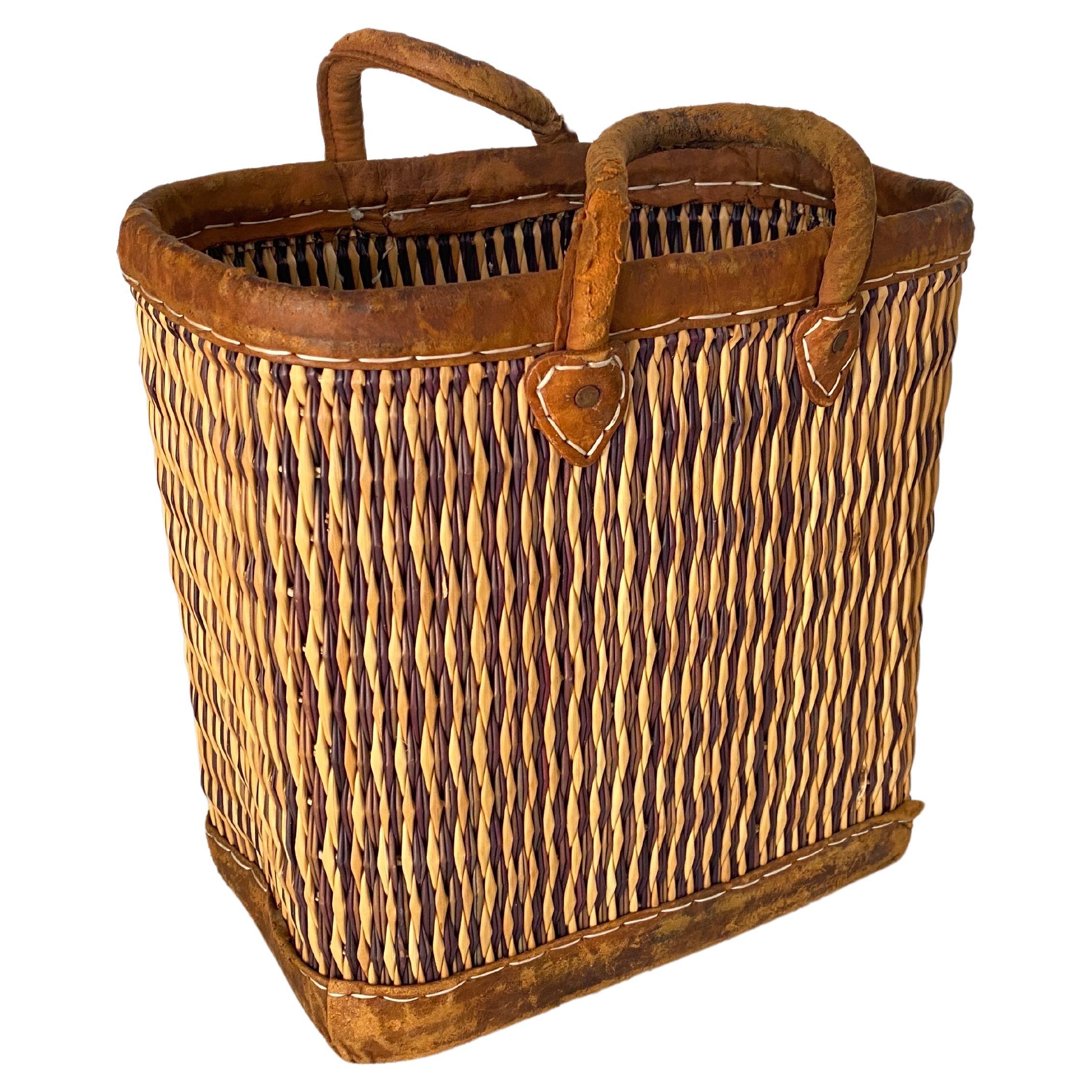 This bag is is wicker, rattan, with Stitched leather bag handles. the color is gold, with an old Patina.
This has been made in France circa 1970.
  