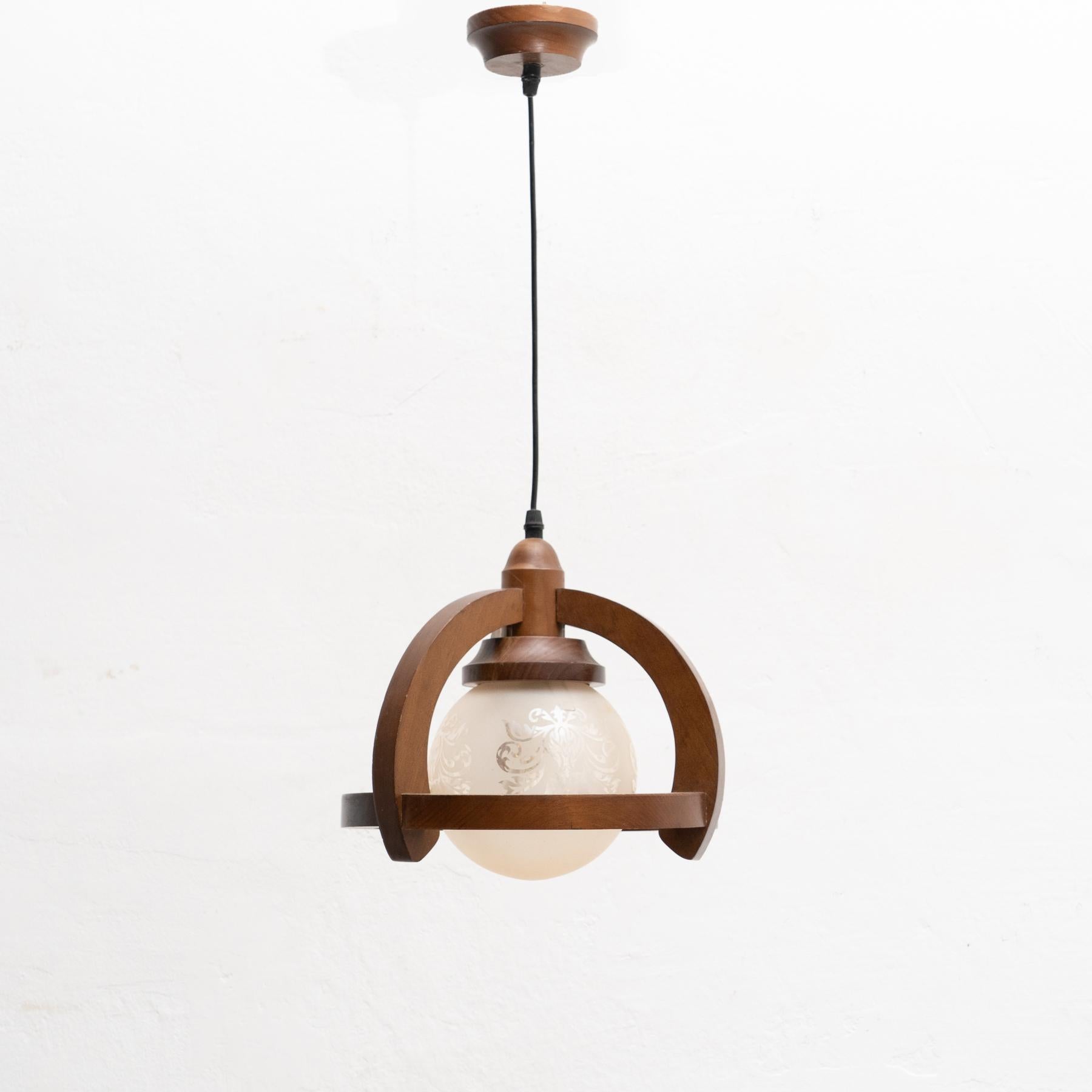 French vintage wooden and white glass decorated ceiling lamp.    By unknown manufacturer from France, circa 1960.    In original condition, with minor wear consistent with age and use, preserving a beautiful patina.    Materials:  Glass  Wood.     