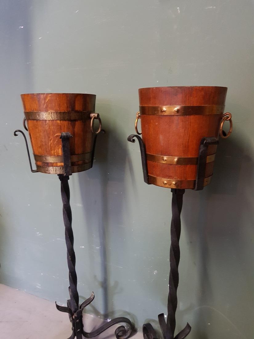 Vintage French oak champagne or wine coolers on wrought iron standard with aluminum inner tray, both are in a good but used condition. Originating from the 1960s-1970s.

The measurements are,
Diameter 20 cm/ 7.8 inch.
Height 91.5 cm/ 36 inch.