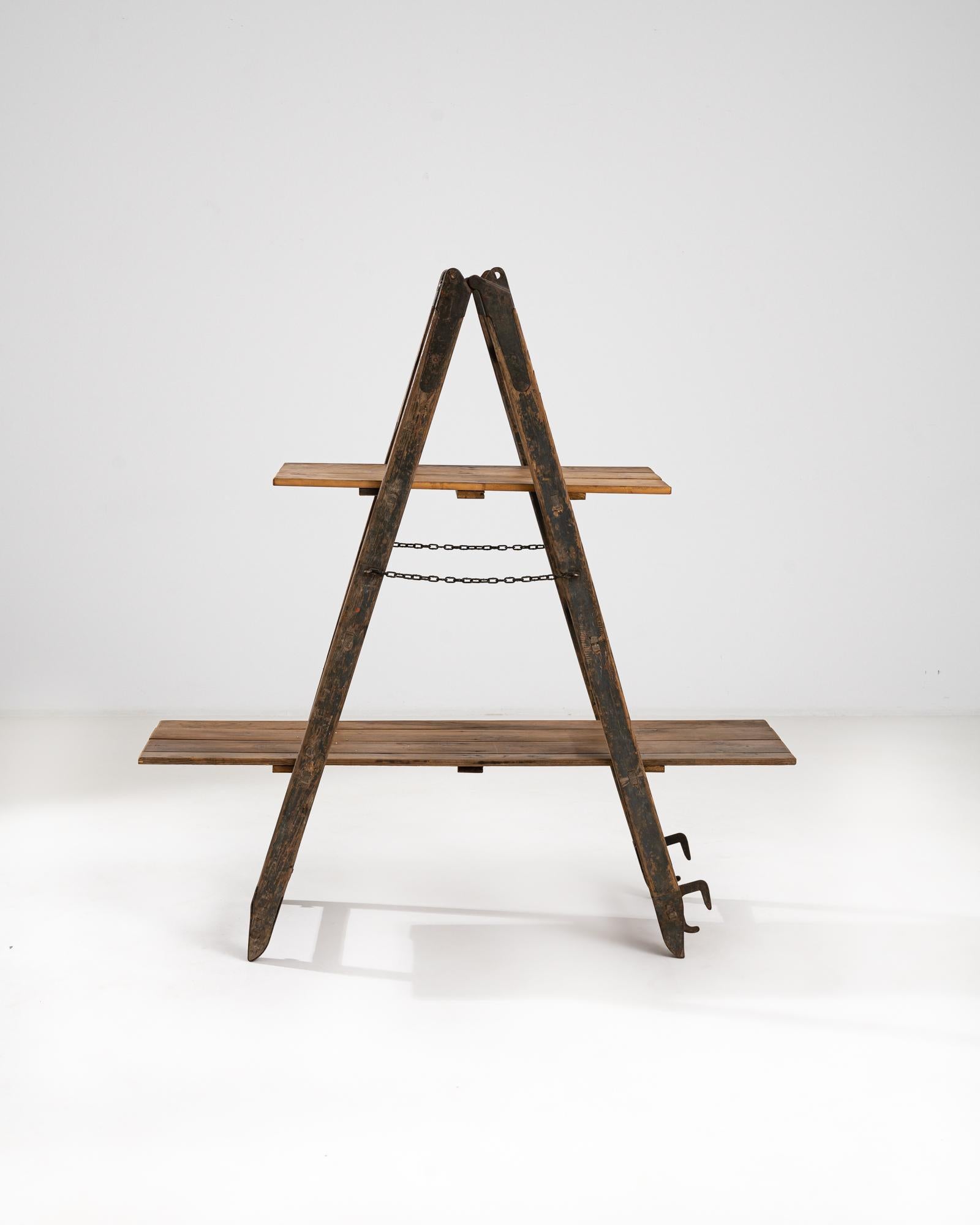A vintage ladder from early 20th Century France, refigured into a two level shelving unit. Conjuring images of bricolage, this time-traveled object displays a nostalgic patina; scuffs and dings, drips of paint record the telltale stories of projects