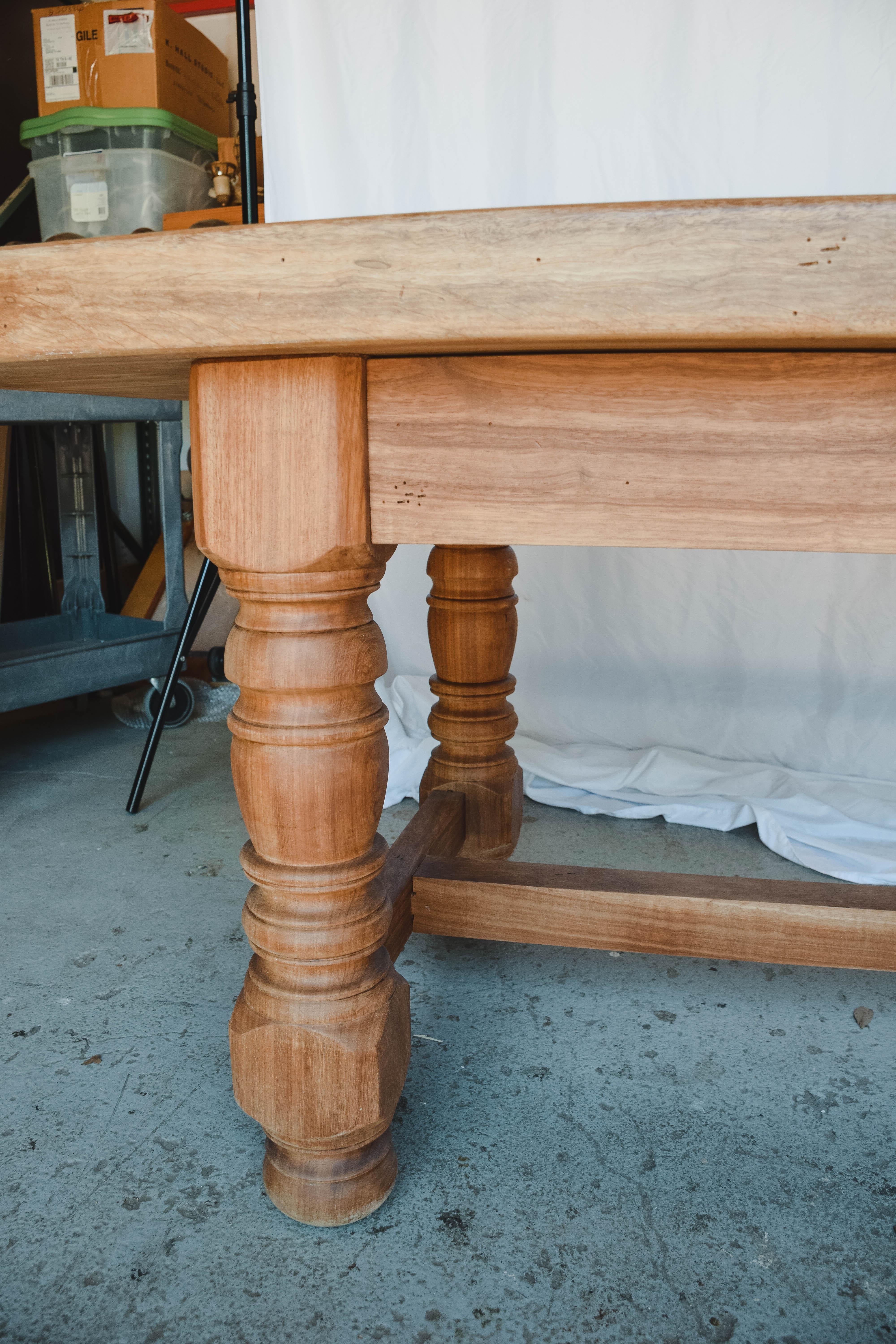 Found in the South of France, this vintage French work table is constructed with a thick solid wood top and turned legs. A large size, makes this table ideal for a kitchen work surface or island. The wood pegged bottom stretcher only adds to the
