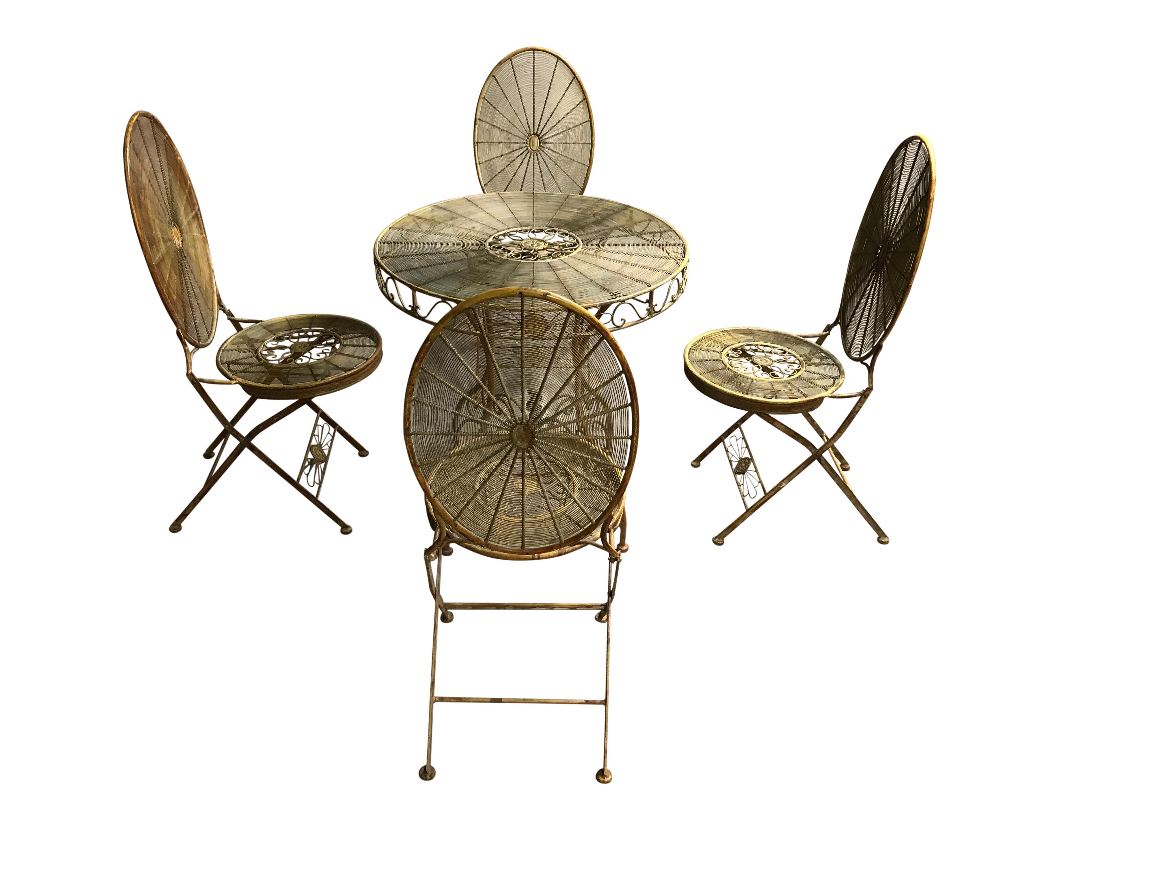 Vintage wrought iron garden or patio set.

Elegant shaped legs with metal wire seats, backrests and tabletop.

This set has the right patinated look and is not 'super' heavy, so it is easily usable.

The chairs are foldable.

The set has a