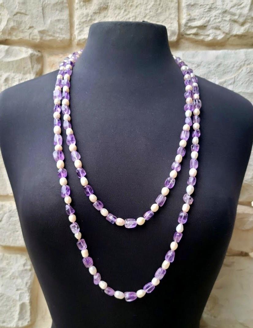 This beautiful, elegant, classic, very long necklace is made of natural freshwater pearls and natural lavender amethyst. The vintage necklace is from about 50-60 years of the last century.

The length of the necklace is 66 inches (167.6 cm). The