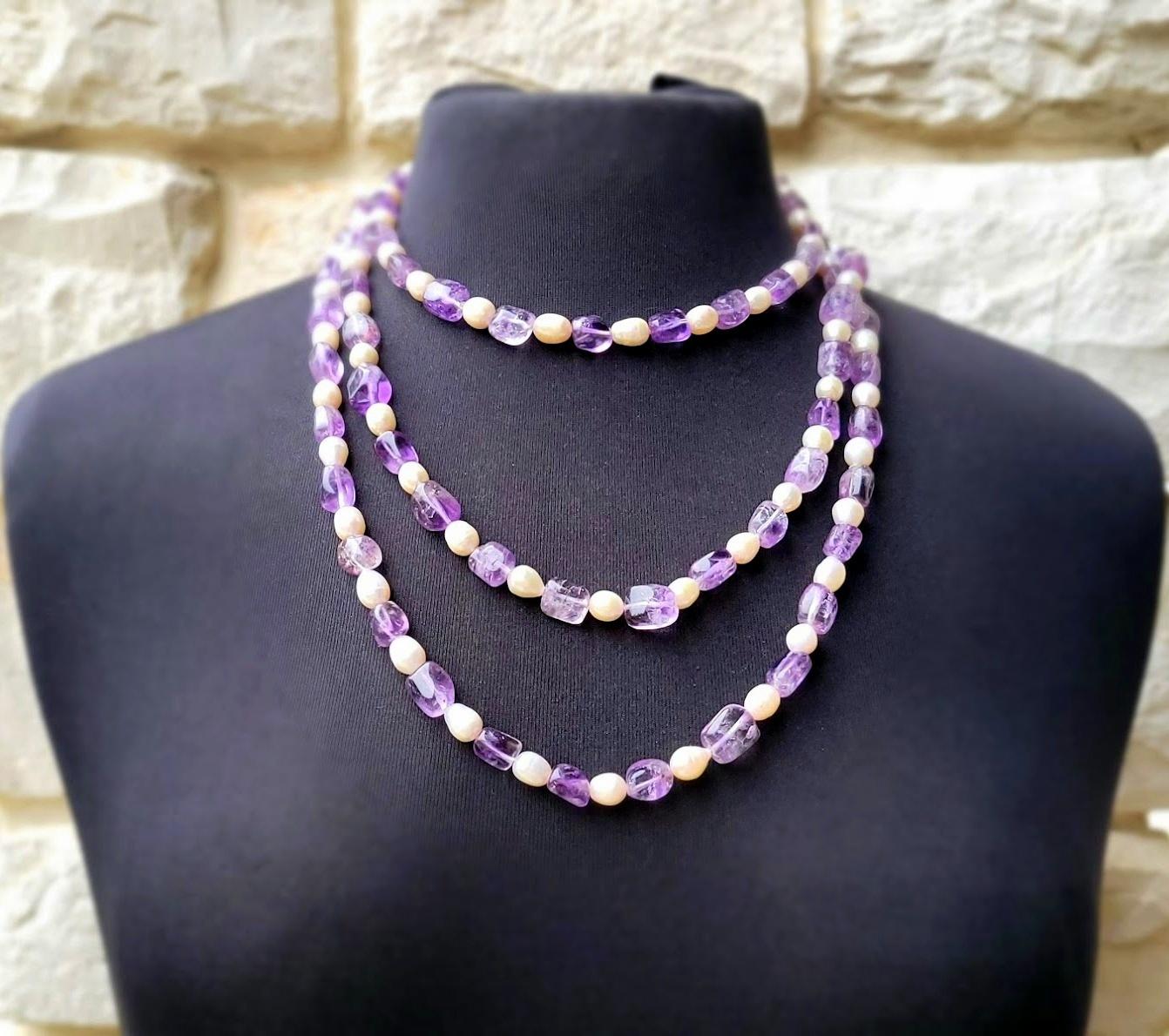 Introducing our elegant long necklace, made of natural freshwater pearls and natural lavender amethyst in the classic Art Deco style of 20-40 years ago.

The necklace measures an impressive 66 inches (167.6 cm) in length and features