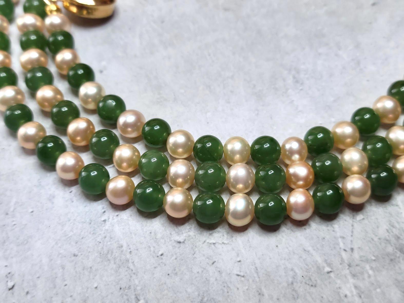 This beautiful, elegant, classic, long necklace is made of natural freshwater peach pearls and natural Russian green nephrite of very high quality from Siberia. The nephrite beads are pure, uniform, soft green color, delicate and shiny, and they're