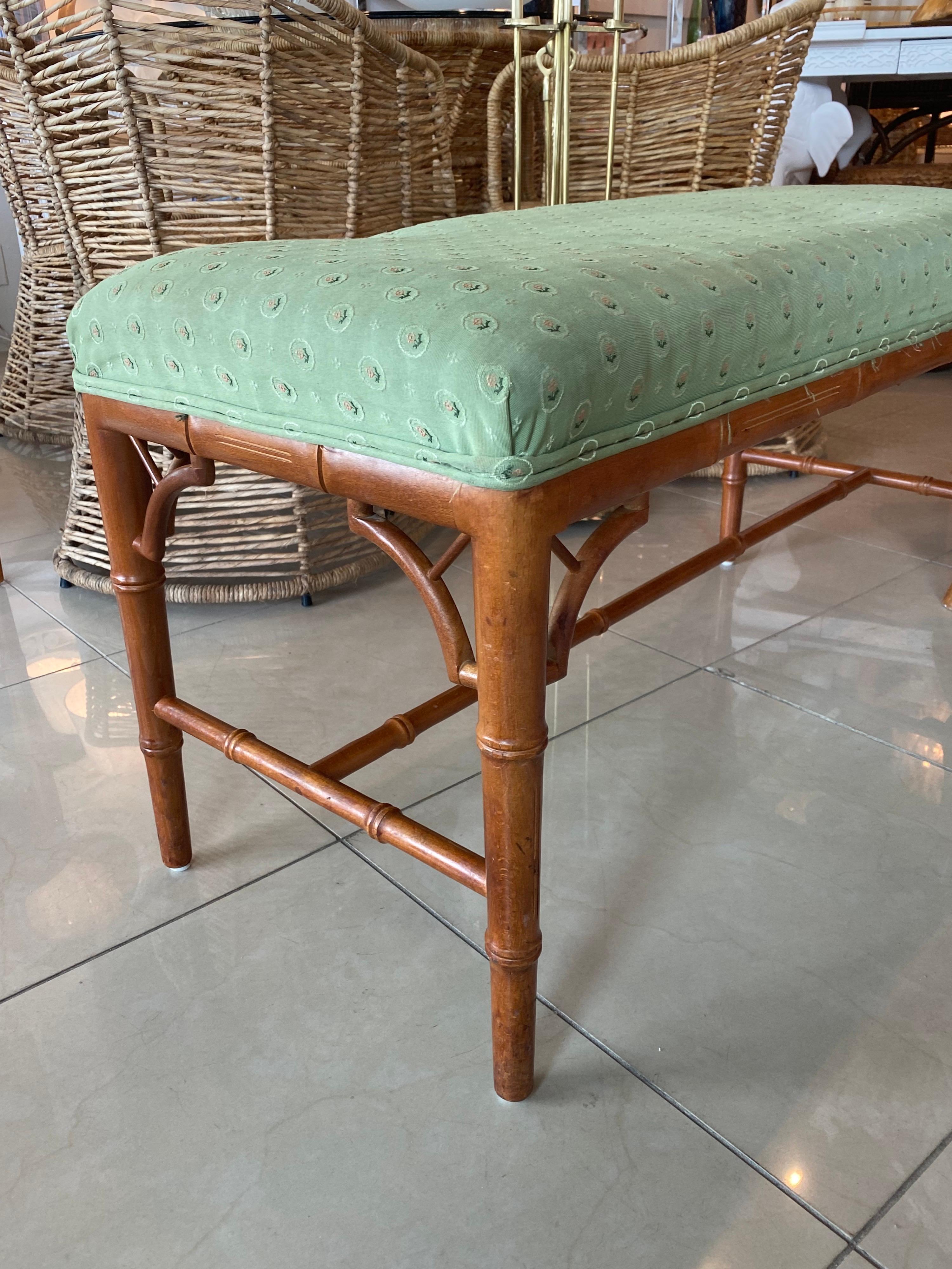 Vintage wood faux bamboo bench. Upholstery is original and will absolutely need to be recovered. May have stains, holes, dirt and indents to foam cushion interior from stacking. Wood finish is original. Original wood finish may have color variation,